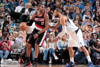 DALLAS, TX - APRIL 15: LaMarcus Aldridge #12 of the Portland Trail Blazers posts up against Tyson Chandler #6 of the Dallas Mavericks on April 15, 2015 at the American Airlines Center in Dallas, Texas. NOTE TO USER: User expressly acknowledges and agrees 