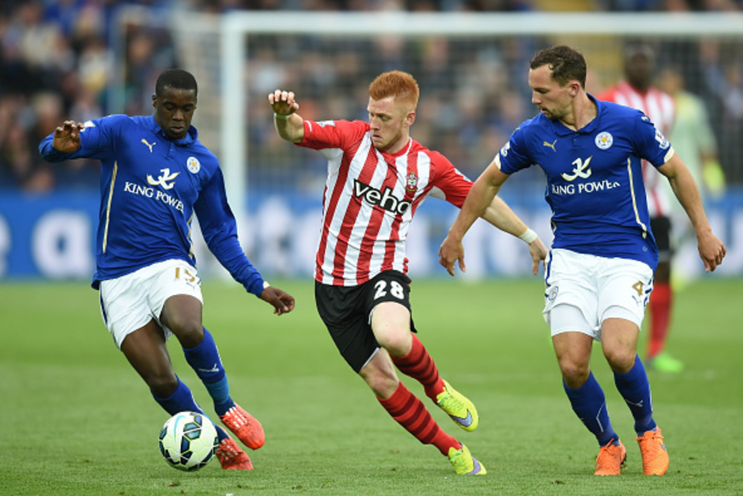 LEICESTER, ENGLAND - MAY 09: Harrison Reed of Southampton is closed down by Jeffrey Schlupp (L) and Danny Drinkwater of Leicester City during the Barclays Premier League match between Leicester City and Southampton at The King Power Stadium on May 9, 2015