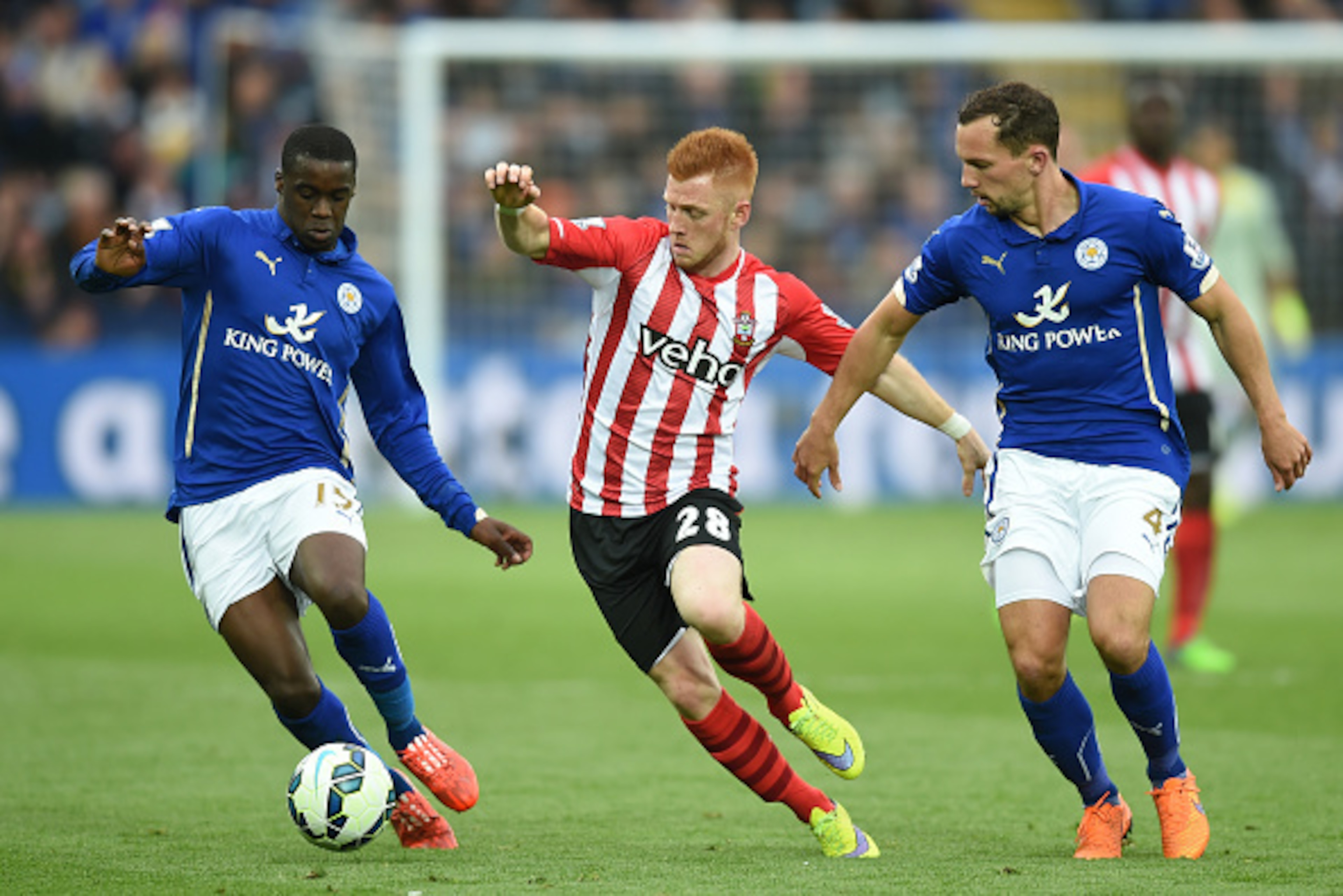 LEICESTER, ENGLAND - MAY 09: Harrison Reed of Southampton is closed down by Jeffrey Schlupp (L) and Danny Drinkwater of Leicester City during the Barclays Premier League match between Leicester City and Southampton at The King Power Stadium on May 9, 2015