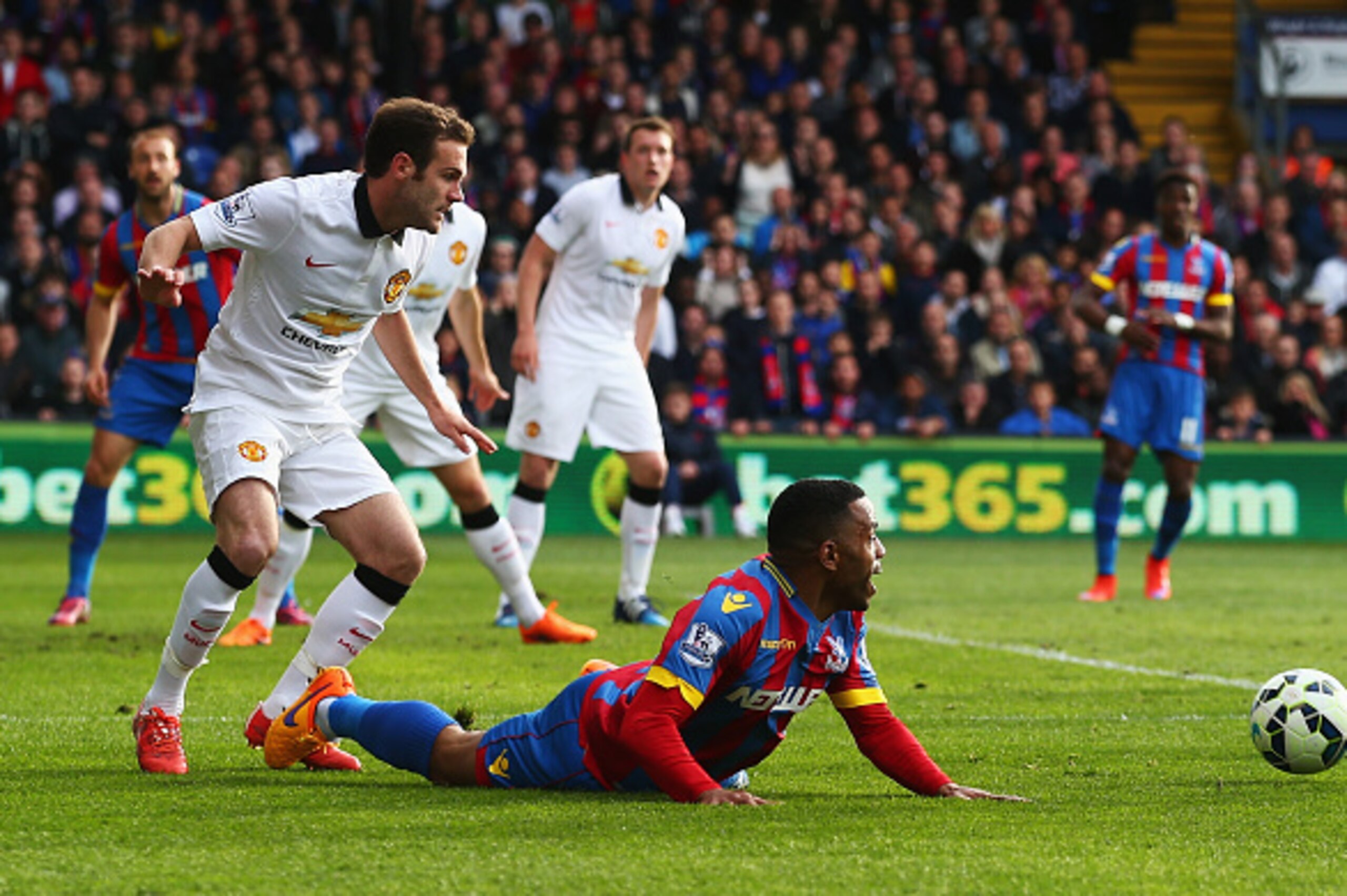LONDON, ENGLAND - MAY 09:  Juan Mata of Manchester United trips Jason Puncheon of Crystal Palace but a penalty is not given during the Barclays Premier League match between Crystal Palace and Manchester United at Selhurst Park on May 9, 2015 in London, En