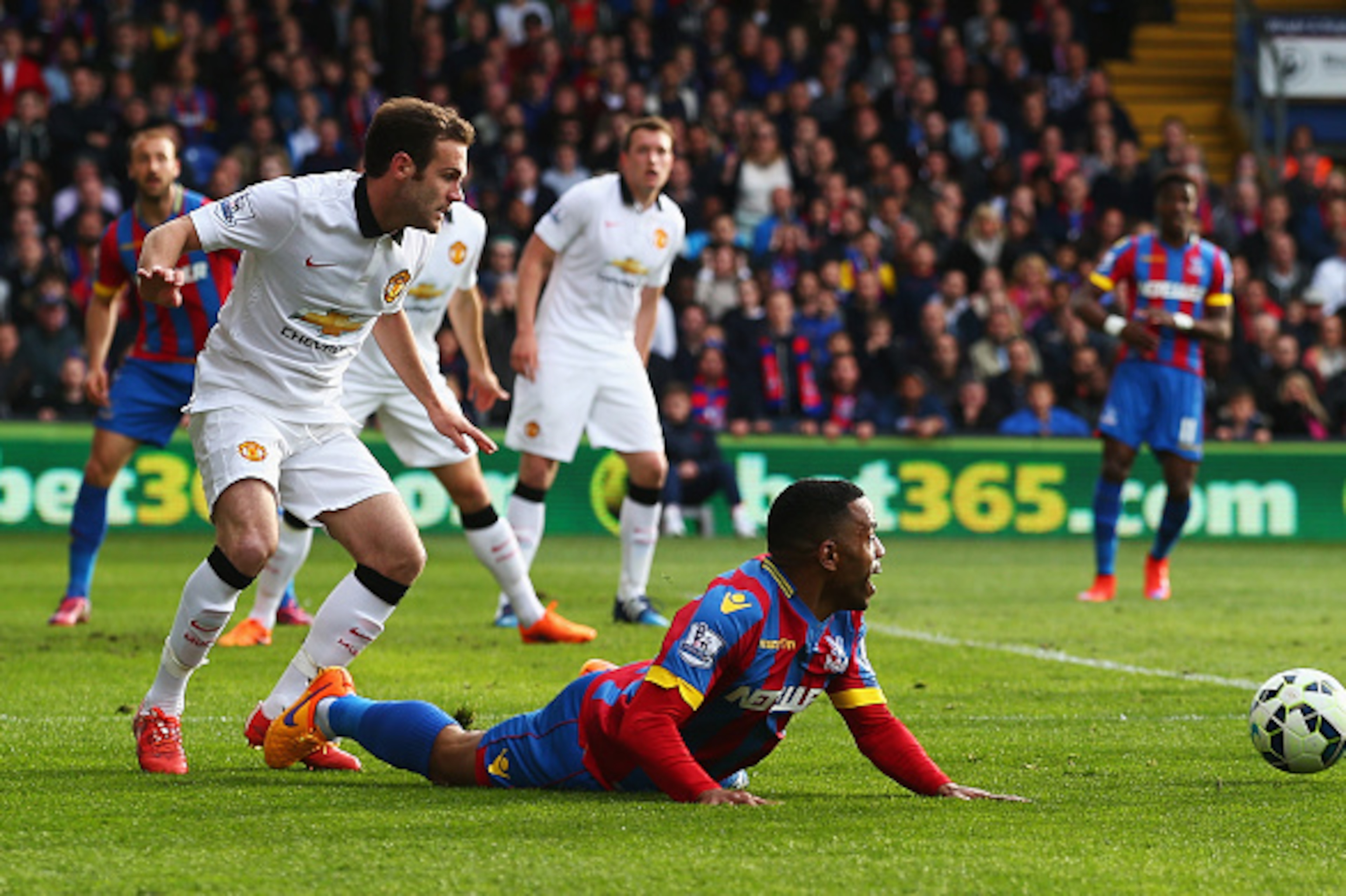 LONDON, ENGLAND - MAY 09:  Juan Mata of Manchester United trips Jason Puncheon of Crystal Palace but a penalty is not given during the Barclays Premier League match between Crystal Palace and Manchester United at Selhurst Park on May 9, 2015 in London, En
