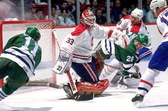 MONTREAL - 1980's: Goaltender Patrick Roy # 33, Craig Ludwig #17 and Larry Robinson #19 of the Montreal Canadiens defends against Kevin Dineen #11 and Lindsay Carson #28 of the Hartford Whalers. (Photo by Denis Brodeur/NHLI via Getty Images)