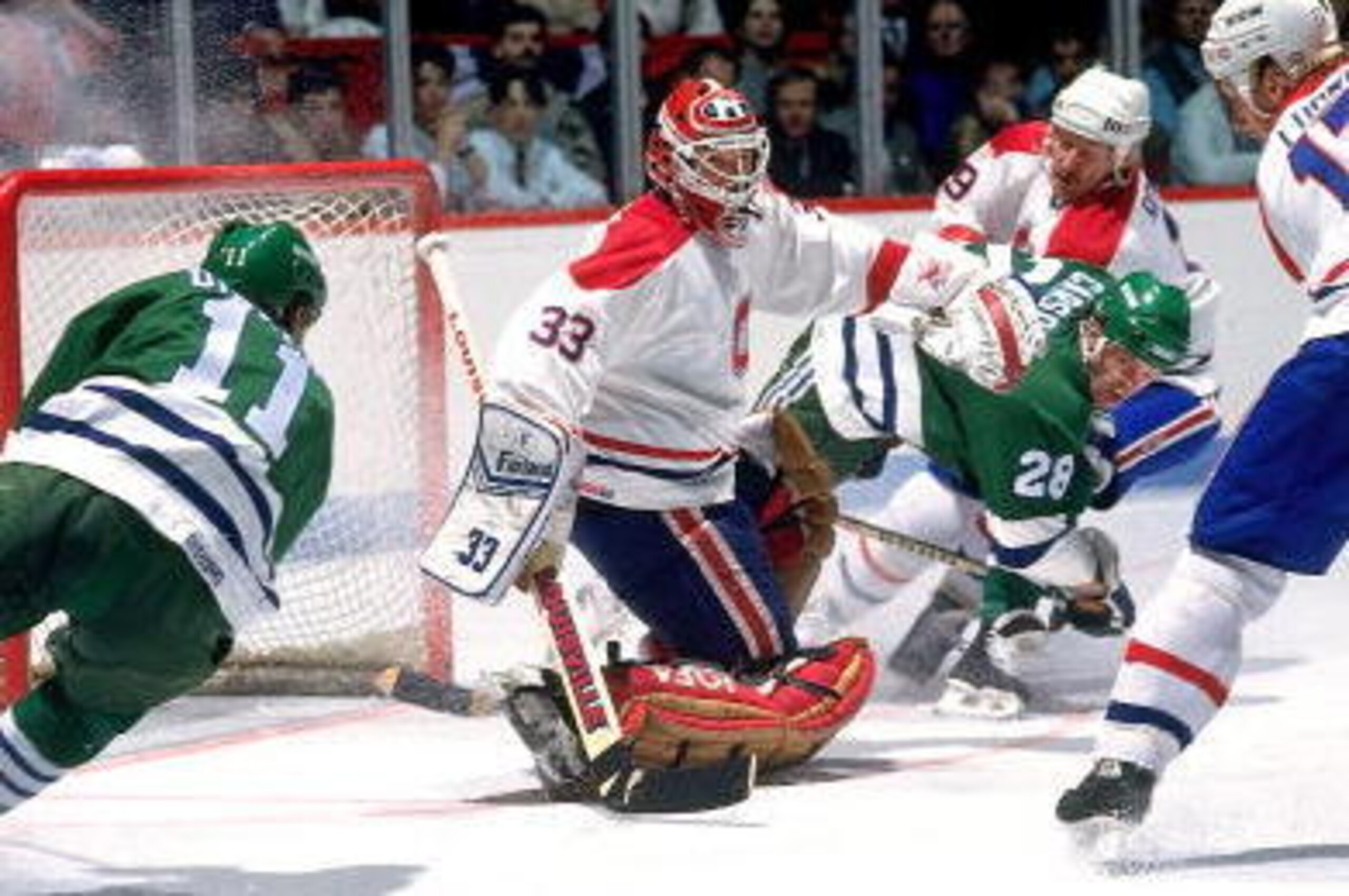 MONTREAL - 1980's: Goaltender Patrick Roy # 33, Craig Ludwig #17 and Larry Robinson #19 of the Montreal Canadiens defends against Kevin Dineen #11 and Lindsay Carson #28 of the Hartford Whalers. (Photo by Denis Brodeur/NHLI via Getty Images)