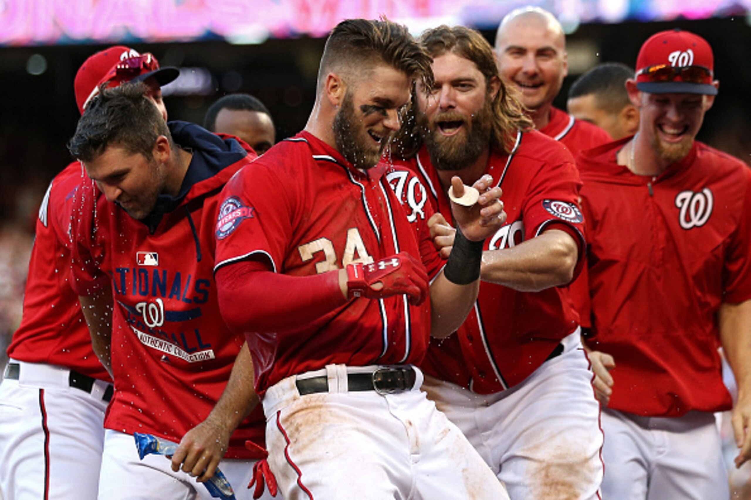 WASHINGTON, DC - MAY 09: Bryce Harper #34 of the Washington Nationals celebrates with teammates after hitting a walk off home run in the ninth inning against the Atlanta Braves at Nationals Park on May 9, 2015 in Washington, DC. The Washington Nationals w