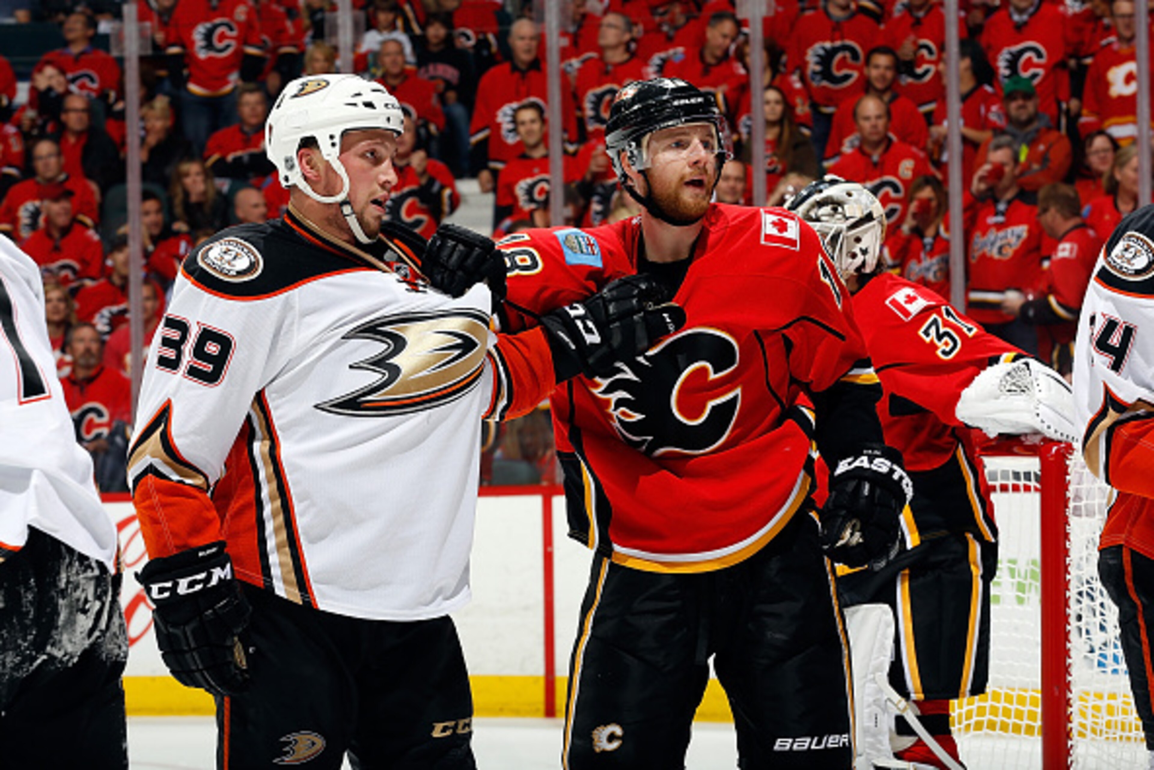 CALGARY, AB - MAY 8: Matt Stajan #18 of the Calgary Flames jostles with Matt Beleskey #39 of the Anaheim Ducks at Scotiabank Saddledome for Game Four of the Western Quarterfinals during the 2015 NHL Stanley Cup Playoffs on May 8, 2015 in Calgary, Alberta,