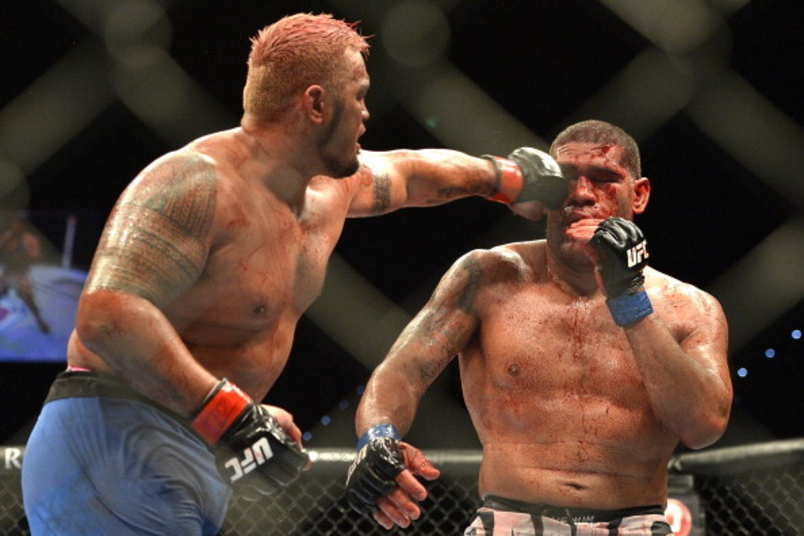 BRISBANE, AUSTRALIA - DECEMBER 07:  Mark Hunt connects with a punch during the UFC Brisbane bout between Mark Hunt and Antonio 'Big Foot' Silva of Brazil at the Brisbane Entertainment Centre on December 7, 2013 in Brisbane, Australia.  (Photo by Bradley K