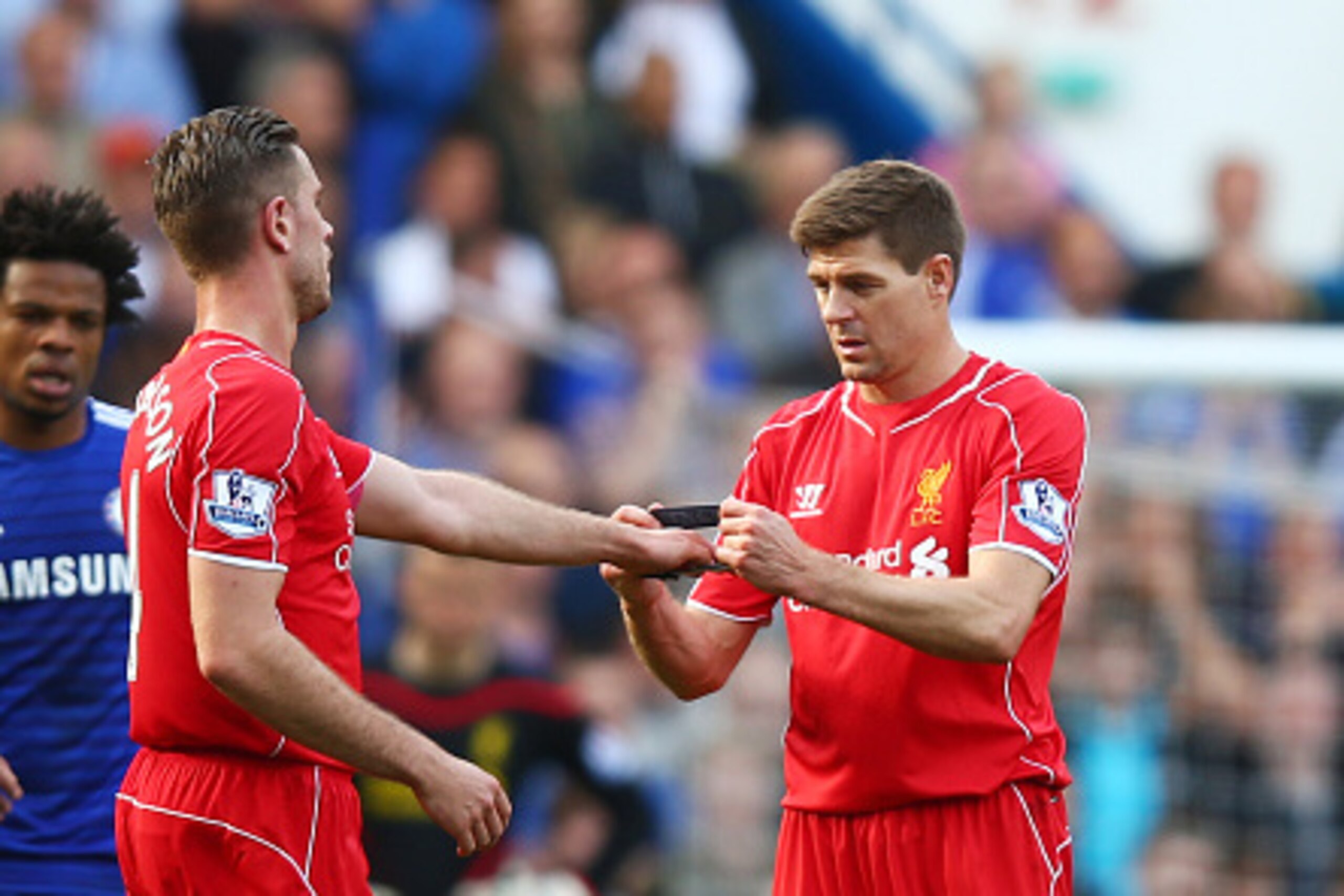LONDON, ENGLAND - MAY 10:  Steven Gerrard of Liverpool hands the captain's armband to Jordan Henderson of Liverpool as he is substiytuted in the second half during the Barclays Premier League match between Chelsea and Liverpool at Stamford Bridge on May 1