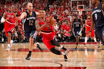 PORTLAND, OREGON - April 25: Damian Lillard #0 of the Portland Trail Blazers drives to the basket against the Memphis Grizzlies during Game Three of the Western Conference Quarterfinals during the NBA Playoffs on April 25, 2015 at Moda Center in Houston, 