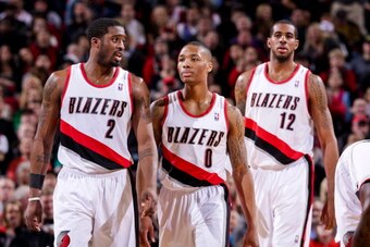 PORTLAND, OR - JANUARY 13: Portland Trail Blazers players Wesley Matthews #2, Damian Lillard #0 and LaMarcus Aldridge #12 wait to resume action against the Oklahoma City Thunder on January 13, 2013 at the Rose Garden Arena in Portland, Oregon. NOTE TO USE