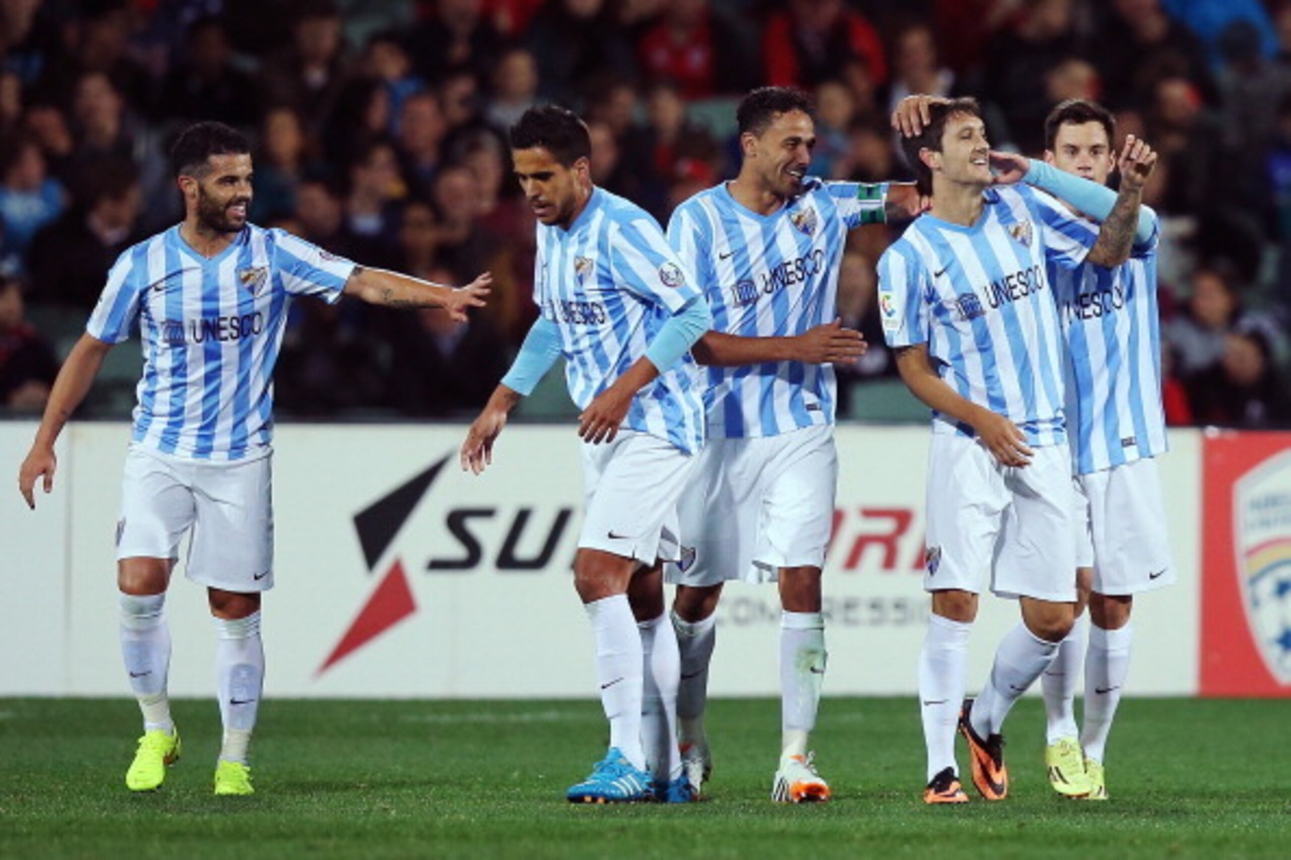 ADELAIDE, AUSTRALIA - JULY 25: Luis Alberto (2R) of Malaga celebrates with teammate after he scored a goal during the international club friendly match between Adelaide United and Malaga CF at Adelaide Oval on July 25, 2014 in Adelaide, Australia.  (Photo