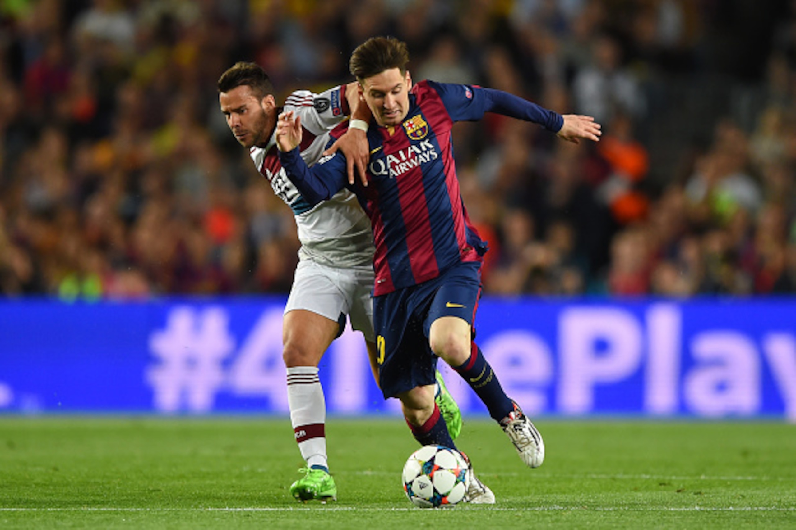 BARCELONA, SPAIN - MAY 06:  Lionel Messi of Barcelona and Juan Bernat of Bayern Muenchen battle for the ball during the UEFA Champions League Semi Final, first leg match between FC Barcelona and FC Bayern Muenchen at Camp Nou on May 6, 2015 in Barcelona, 