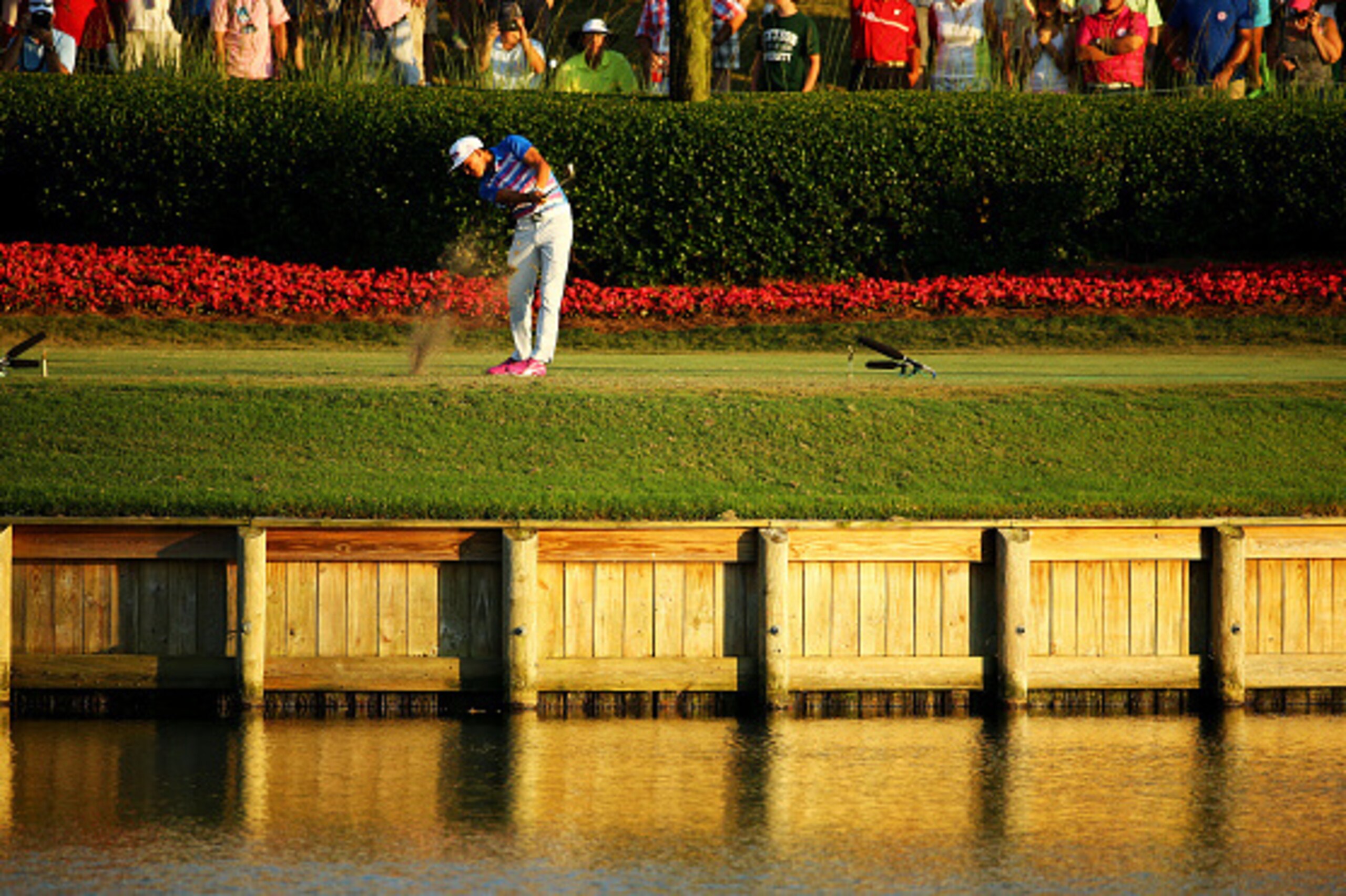 PONTE VEDRA BEACH, FL - MAY 10:  Rickie Fowler plays his shot from the 17th tee during a playoff in the final round of THE PLAYERS Championship at the TPC Sawgrass Stadium course on May 10, 2015 in Ponte Vedra Beach, Florida.  (Photo by Richard Heathcote/