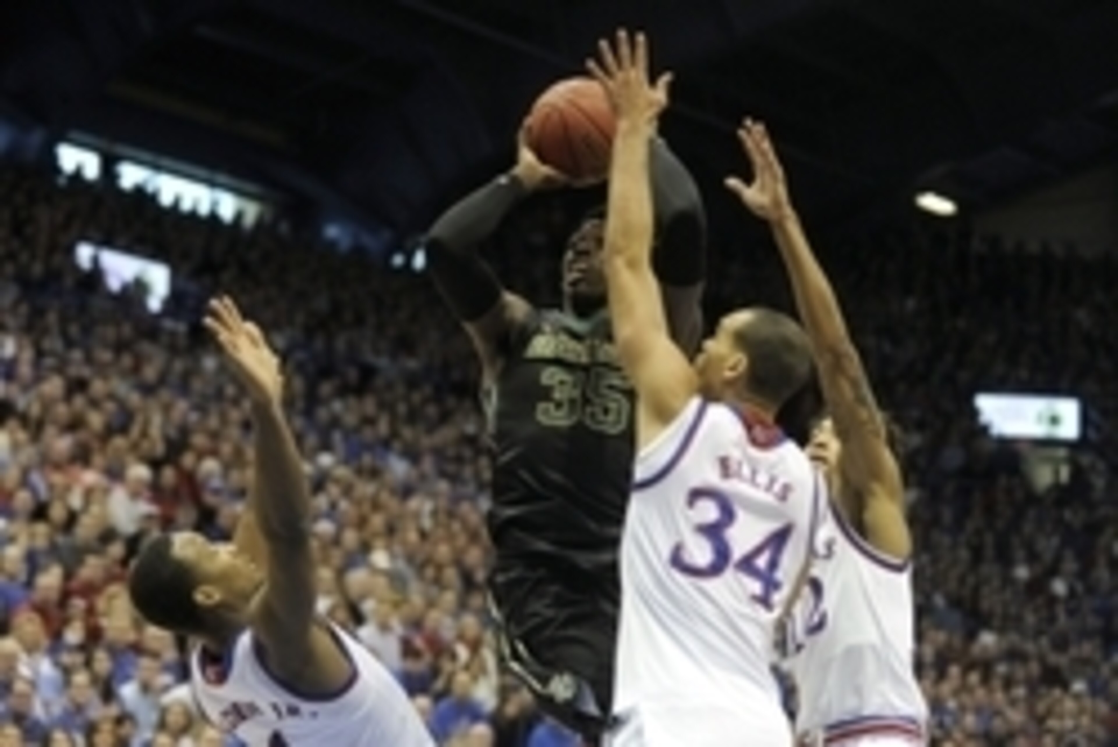 Feb 14, 2015; Lawrence, KS, USA; Baylor Bears forward Johnathan Motley (35) drives to the basket against Kansas Jayhawks guard Wayne Selden Jr. (1), forward Perry Ellis (34) and guard Kelly Oubre Jr. (12) in the first half at Allen Fieldhouse. Mandatory C