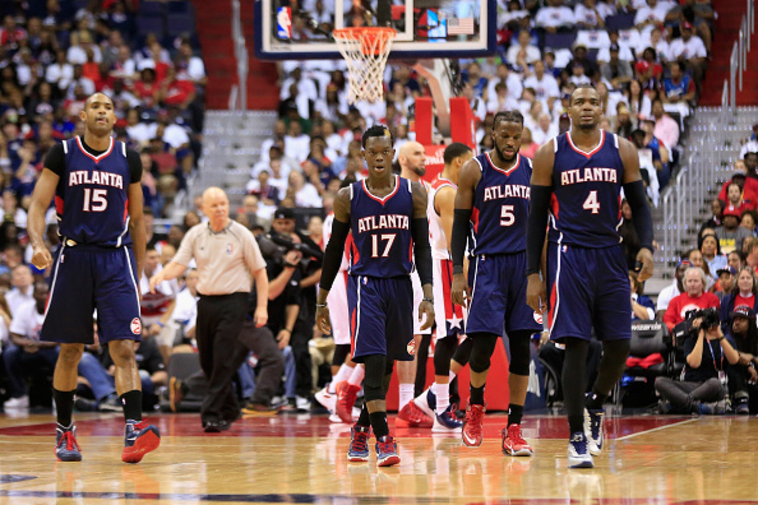 WASHINGTON, DC - MAY 09: Al Horford #15, Dennis Schroder #17, DeMarre Carroll #5, and Paul Millsap #4 of the Atlanta Hawks walk off the floor during a first half time out against the Washington Wizards during Game Three of the Eastern Conference Semifinal