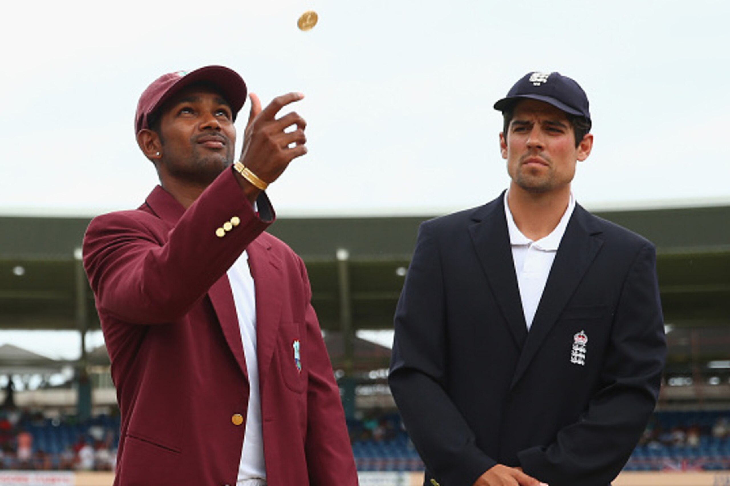 GRENADA, GRENADA - APRIL 21:  Denesh Ramdin (L) the captain of West Indies tosses the coin as England captain Alastair Cook calls heads and opts to bowl  during day one of the 2nd Test match between West Indies and England at the National Cricket Stadium 