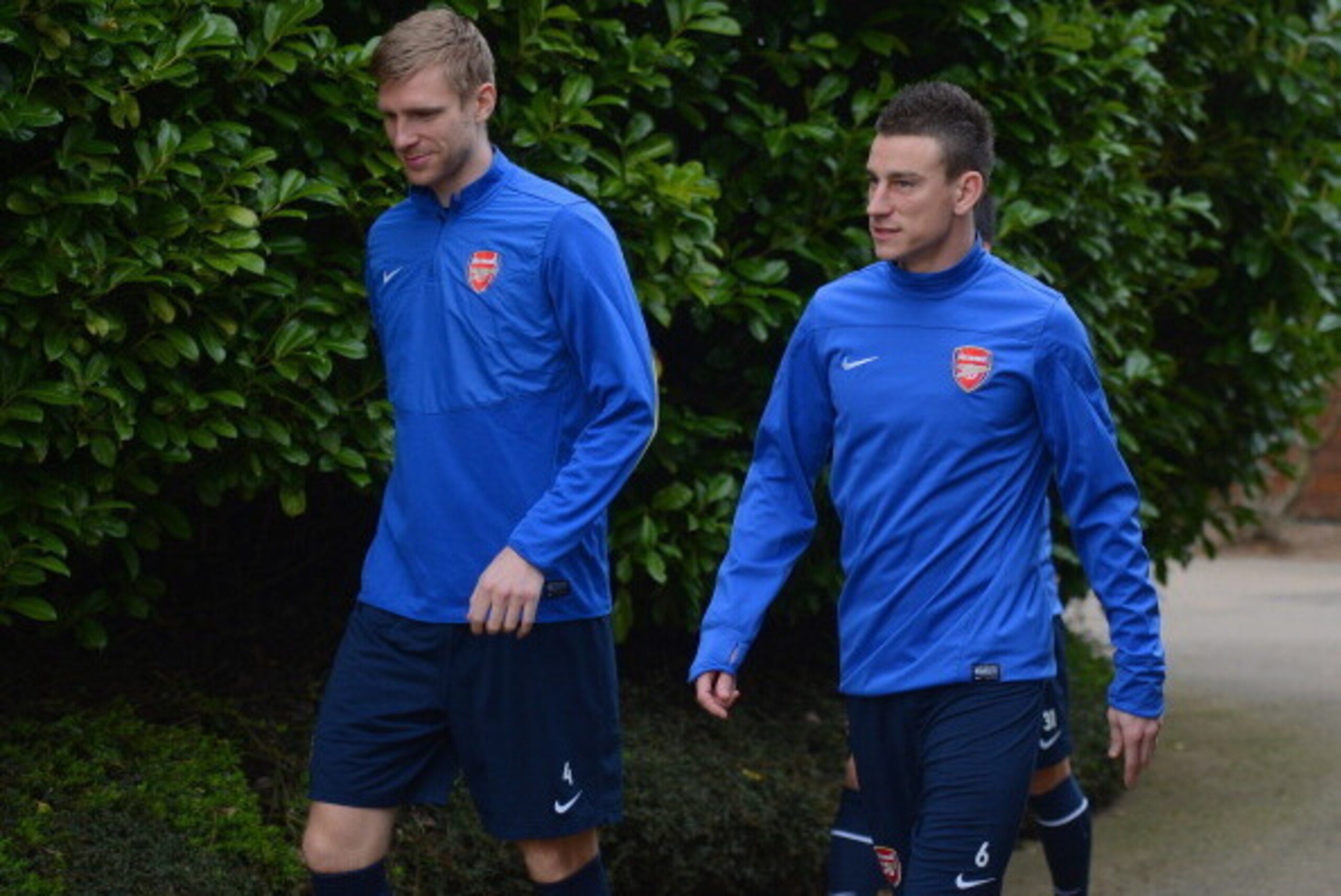 ST ALBANS, ENGLAND - MARCH 10: Per Mertesacker and Laurent Koscielny look on during the Arsenal training session at London Colney on March 10, 2014 in St Albans, England.  (Photo by Michael Regan/Getty Images)