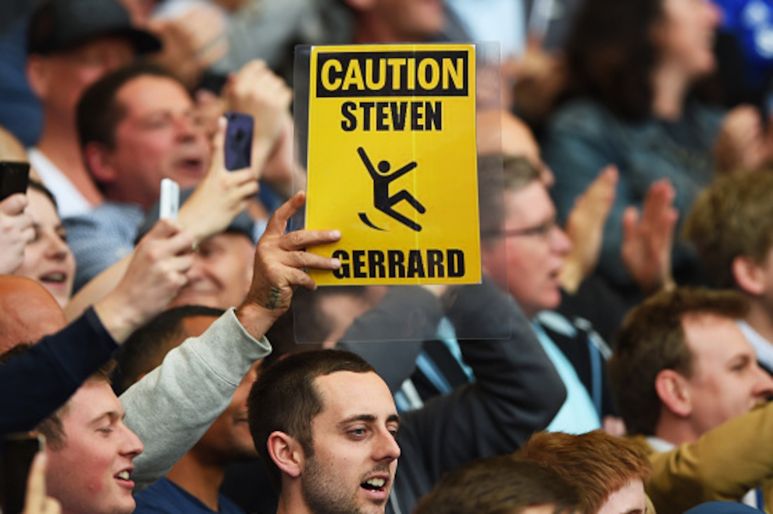 LONDON, ENGLAND - MAY 10:  Chelsea fans hold up banners in reference to Steven Gerrard of Liverpool and his slipping over against their team last year during the Barclays Premier League match between Chelsea and Liverpool at Stamford Bridge on May 10, 201