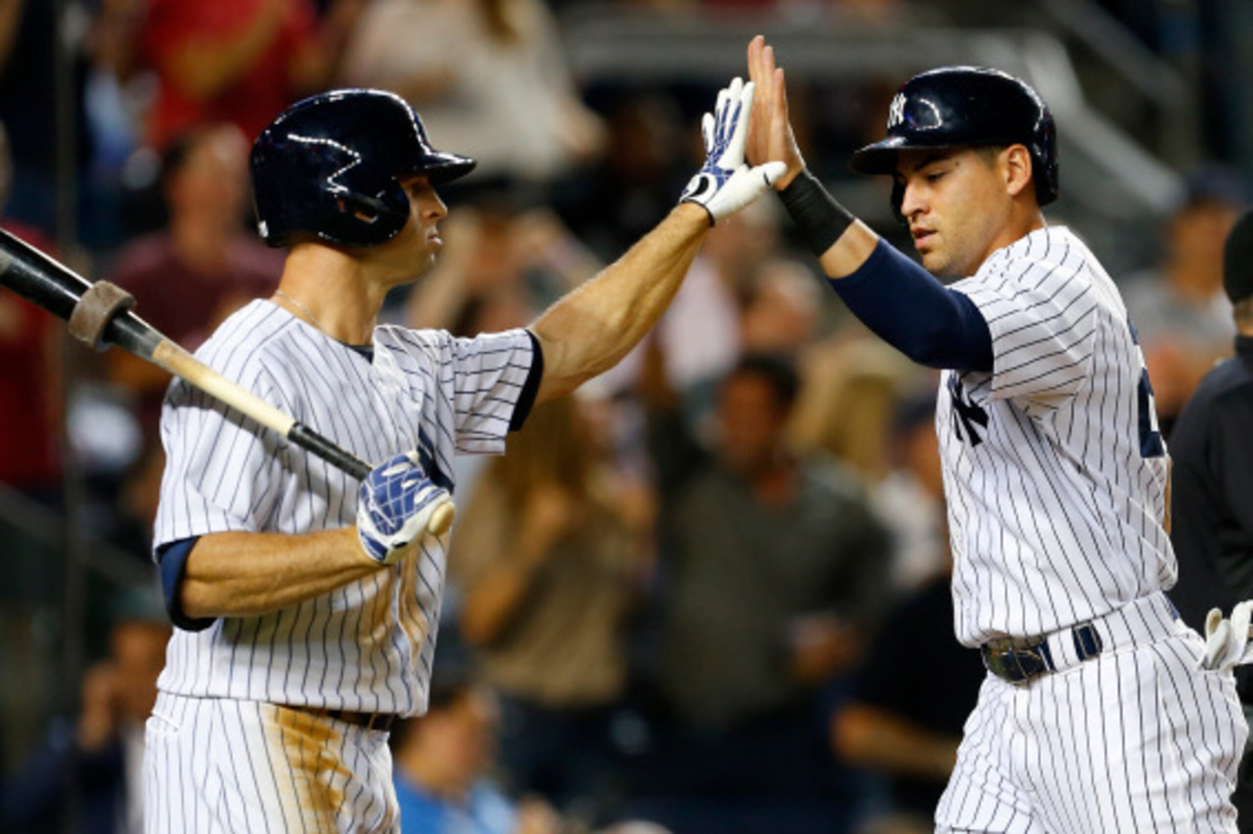 NEW YORK, NY - SEPTEMBER 04: Jacoby Ellsbury #22 of the New York Yankees is congratulated  by Brett Gardner #11 after scoring on a two run double by Derek Jeter #2 in the third inning against the Boston Red Sox during a MLB baseball game at Yankee Stadium