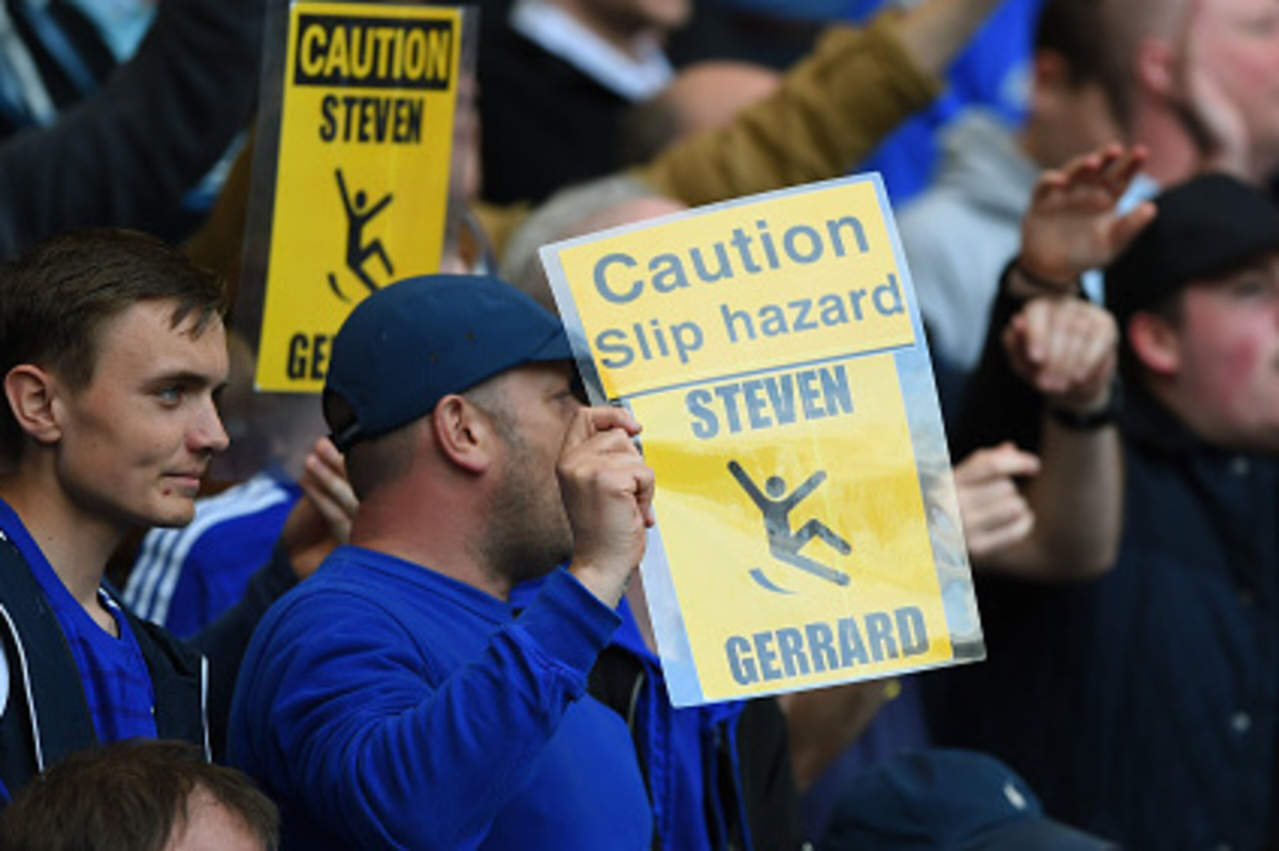 LONDON, ENGLAND - MAY 10:  Chelsea fans hold up banners in reference to Steven Gerrard of Liverpool and his slipping over against their team last year during the Barclays Premier League match between Chelsea and Liverpool at Stamford Bridge on May 10, 201