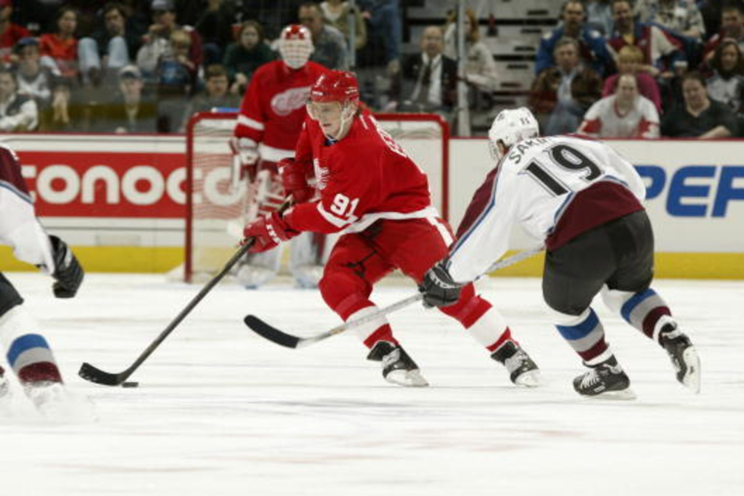 23 Mar 2002 :  Sergei Fedorov #91 of the Detroit Red Wings defends the puck against Joe Sakic #19 of the Colorado Avalanche during the game at the Pepsi Center in Denver, Colorado . The Red Wings won 2-0. DIGITAL IMAGE.  Mandatory Credit: Brian Bahr/Getty