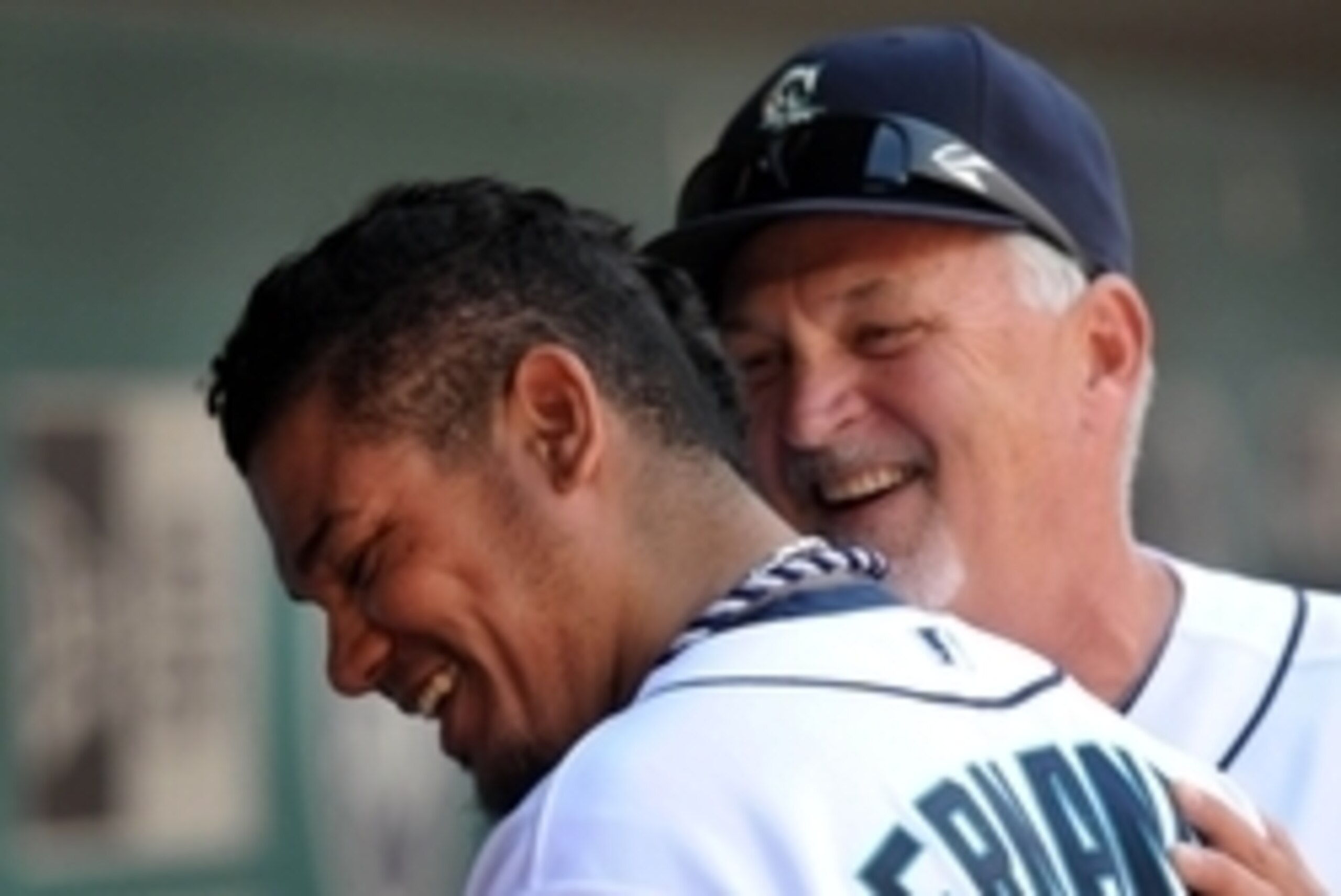 Aug 11, 2013; Seattle, WA, USA; Seattle Mariners starting pitcher Felix Hernandez (34) is greeted in the dugout by pitching coach Carl Willis after the 8th inning of the game against the Milwaukee Brewers at Safeco Field. The Mariners won 2-0. Mandatory C