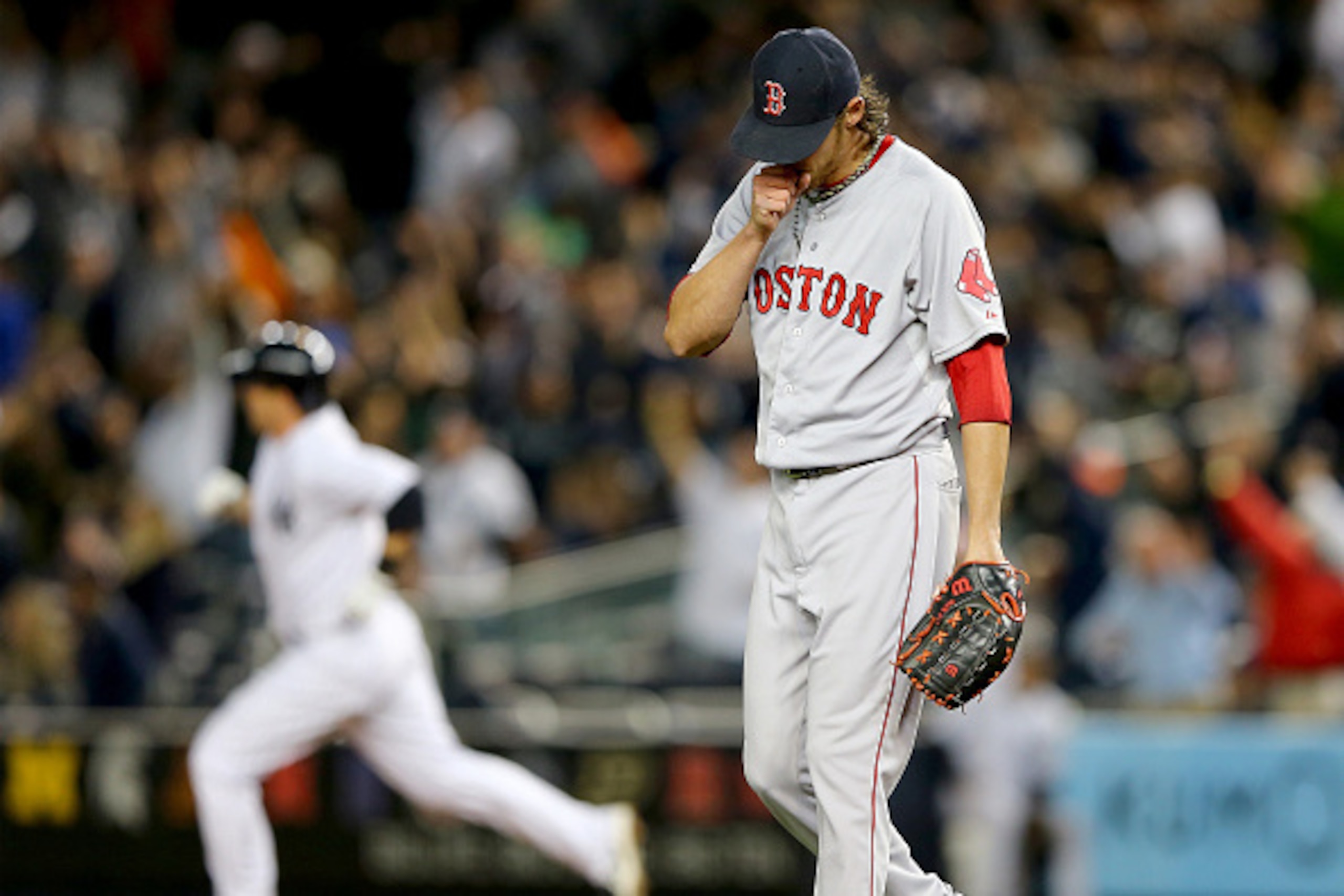 NEW YORK, NY - APRIL 12:  Clay Buchholz #11 of the Boston Red Sox reacts as Stephen Drew #14 of the New York Yankees rounds first after a solo home run in the first inning on April 12, 2015 at Yankee Stadium in the Bronx borough of New York City.  (Photo 
