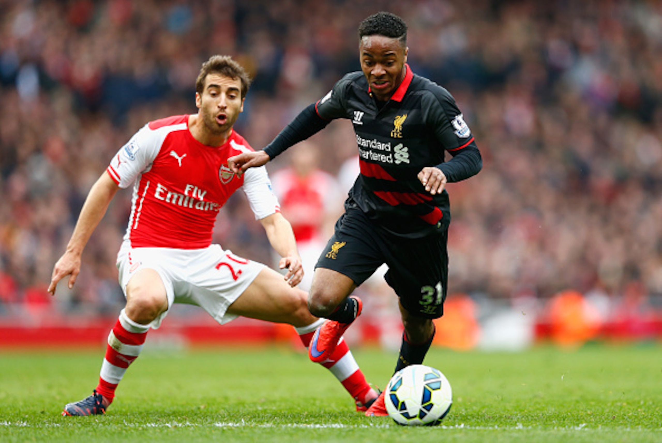 LONDON, ENGLAND - APRIL 04:  Raheem Sterling of Liverpool goes past Mathieu Flamini of Arsenal during the Barclays Premier League match between Arsenal and Liverpool at the Emirates Stadium on April 4, 2015 in London, England.  (Photo by Julian Finney/Get
