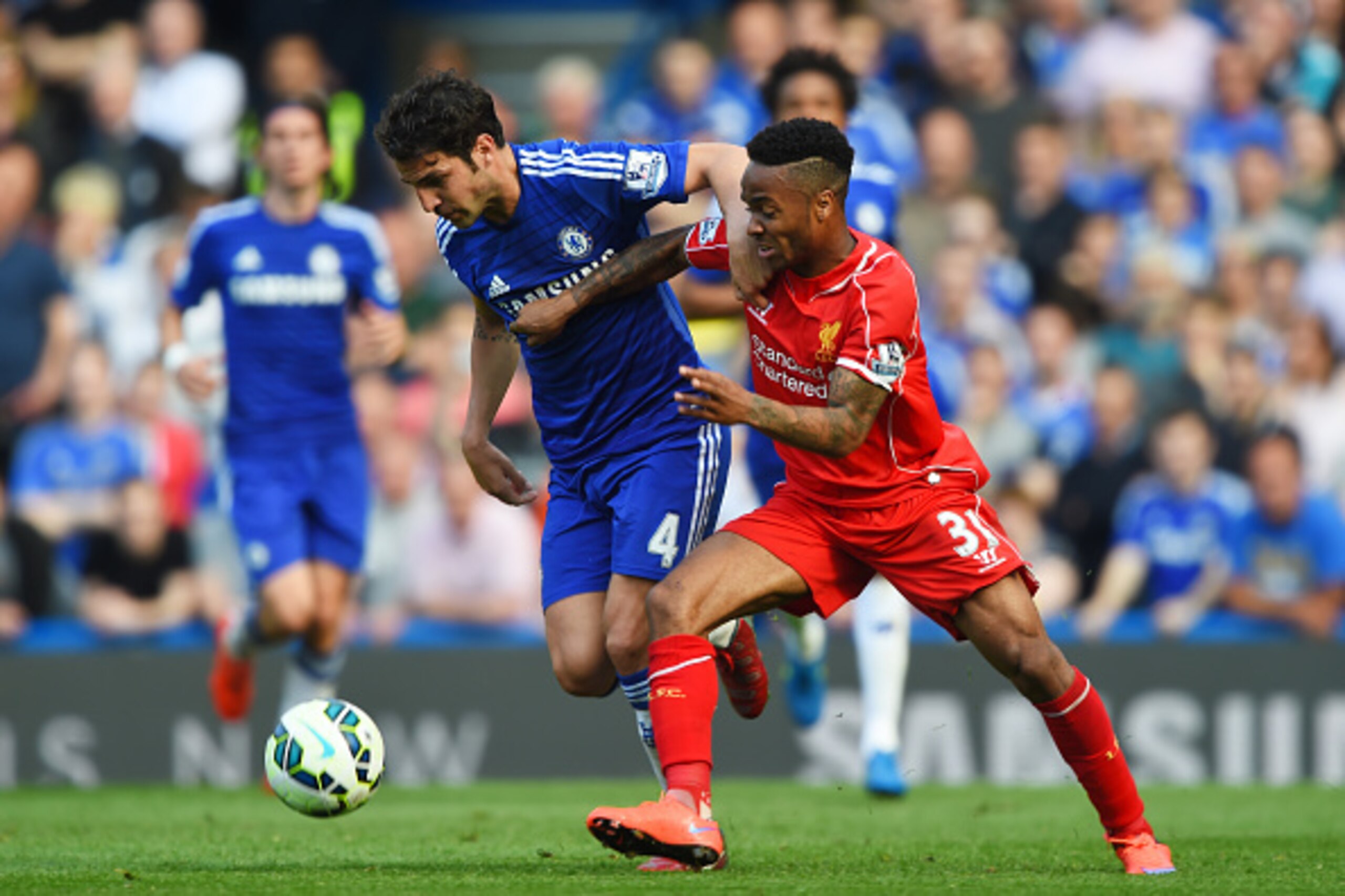 LONDON, ENGLAND - MAY 10:  Cesc Fabregas of Chelsea and Raheem Sterling of Liverpool battle for the ball during the Barclays Premier League match between Chelsea and Liverpool at Stamford Bridge on May 10, 2015 in London, England.  (Photo by Shaun Botteri