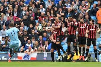 MANCHESTER, ENGLAND - MAY 10:  Aleksandar Kolarov (L) of Manchester City scores his team's second goal from a free kick during the Barclays Premier League match between Manchester City and Queens Park Rangers at the Etihad Stadium on May 10, 2015 in Manch
