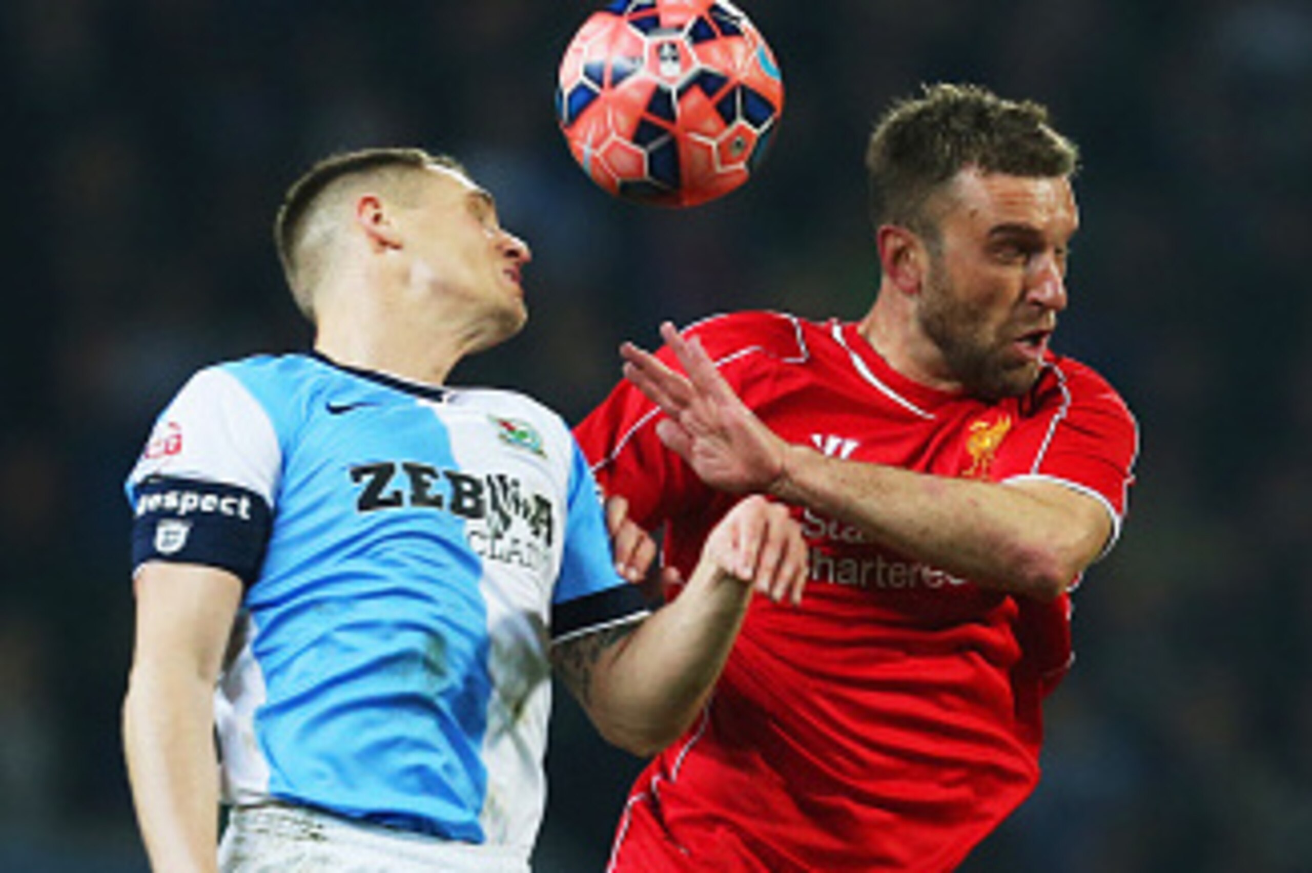 BLACKBURN, ENGLAND - APRIL 08: Rickie Lambert of Liverpool jumps with Matthew Kilgallon of Blackburn Rovers during the FA Cup Quarter Final Replay match between Blackburn Rovers and Liverpool at Ewood Park on April 8, 2015 in Blackburn, England. (Photo BLACKBURN, ENGLAND - APRIL 08: Rickie Lambert of Liverpool jumps with Matthew Kilgallon of Blackburn Rovers during the FA Cup Quarter Final Replay match between Blackburn Rovers and Liverpool at Ewood Park on April 8, 2015 in Blackburn, England. (Photo