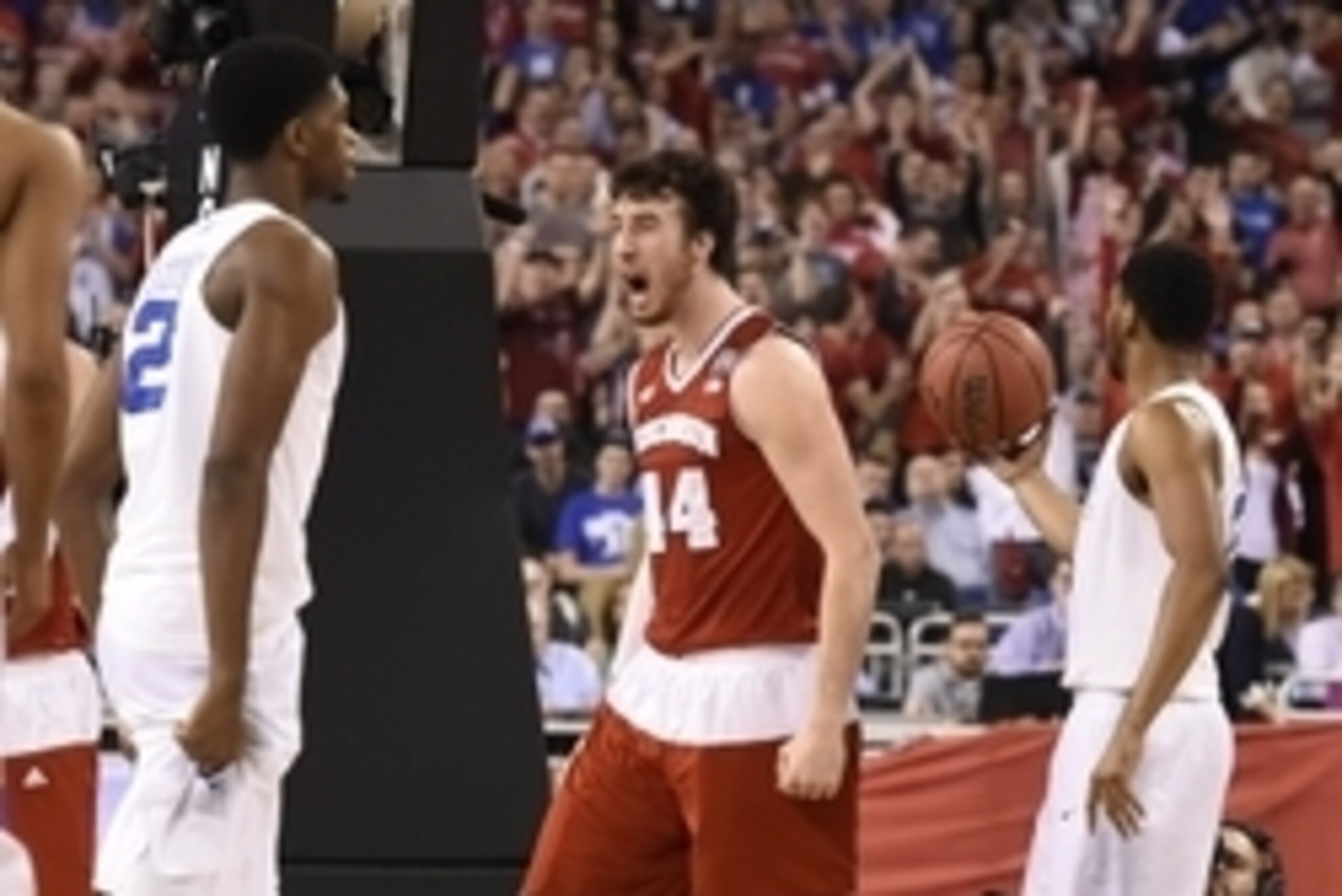 Apr 6, 2015; Indianapolis, IN, USA; Wisconsin Badgers forward Frank Kaminsky (44) reacts after scoring and fouled by Duke Blue Devils center Jahlil Okafor (15) during the first half in the 2015 NCAA Men's Division I Championship game at Lucas Oil Stadium.