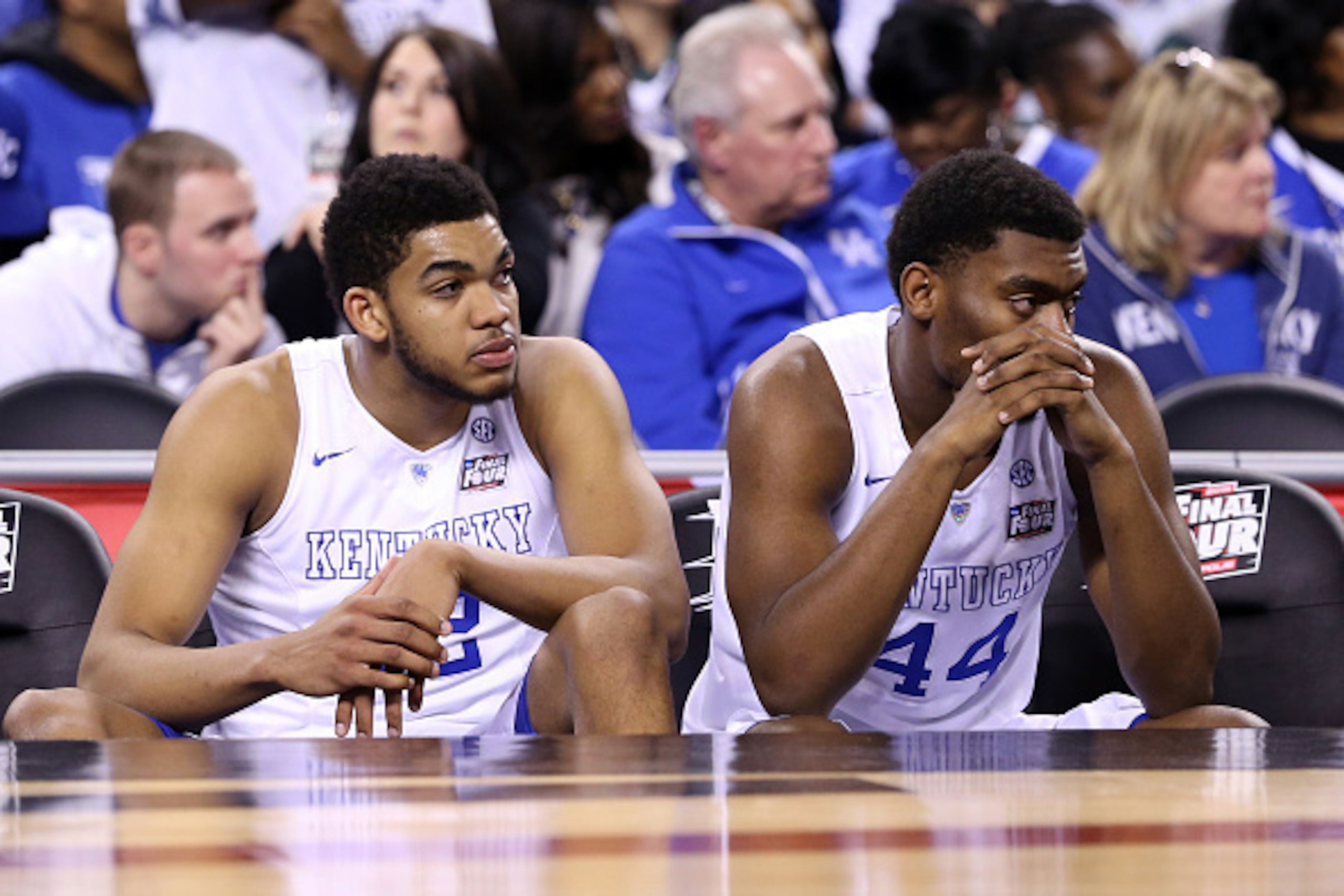 INDIANAPOLIS, IN - APRIL 04: Karl-Anthony Towns #12 and Dakari Johnson #44 of the Kentucky Wildcats look on from the bench late in the game against the Wisconsin Badgers during the NCAA Men's Final Four Semifinal at Lucas Oil Stadium on April 4, 2015 in I