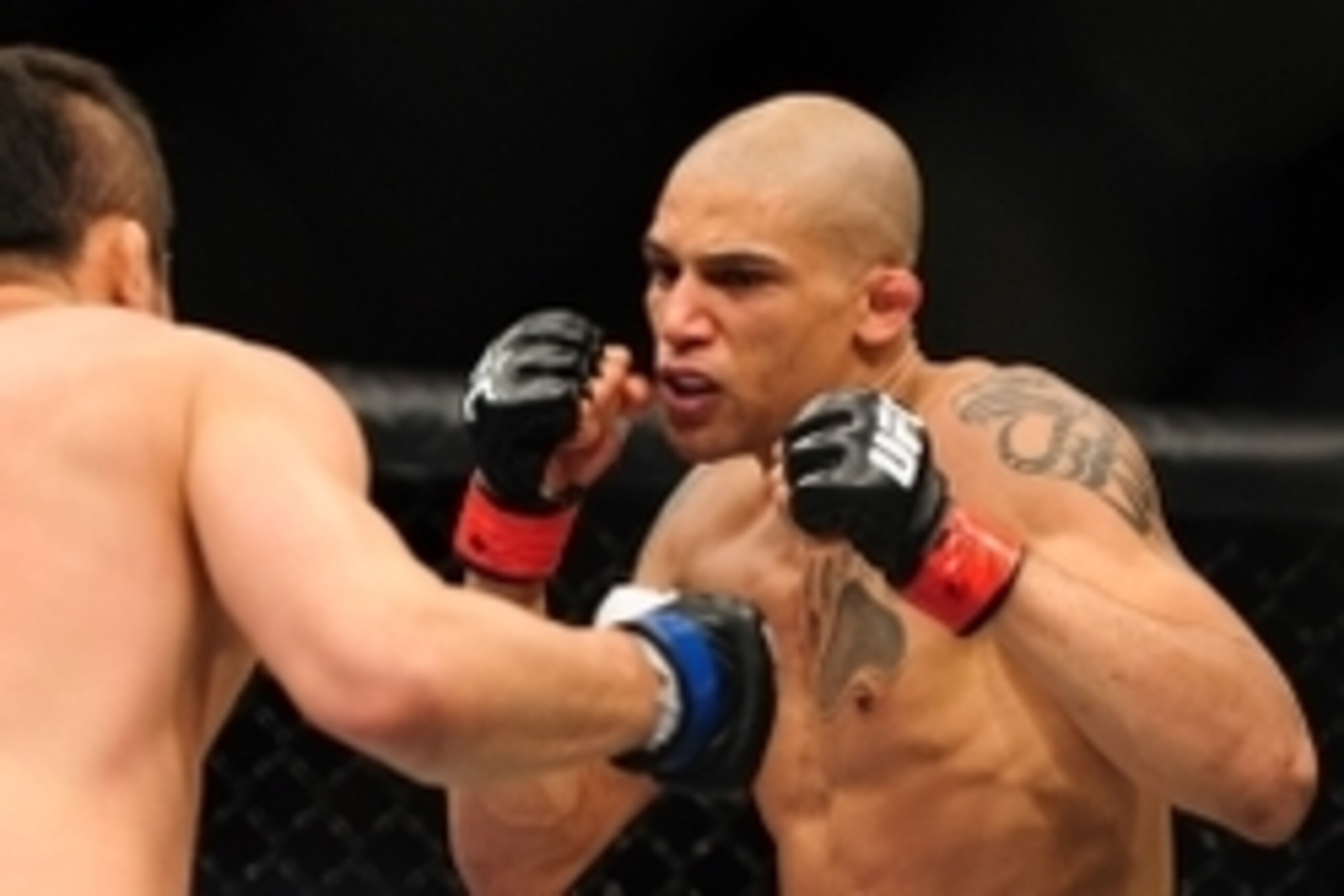 Jun 14, 2014; Vancouver, British Columbia, Canada; Kajan Johnson (red) fights Tae Hyun Bang (blue) in the Lightweight bout bout at UFC 174 at Rogers Arena. -Tae Hyun Bang defeated Kajan Johnson via KO at 2:01 of round 3. Mandatory Credit: Anne-Marie Sorvi