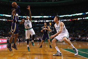 BOSTON, MA - APRIL 01:  Isaiah Thomas #4 of the Boston Celtics defends a shot by C.J. Watson #32 of the Indiana Pacers during the second quarter at TD Garden on April 1, 2015 in Boston, Massachusetts. NOTE TO USER: User expressly acknowledges and agrees t
