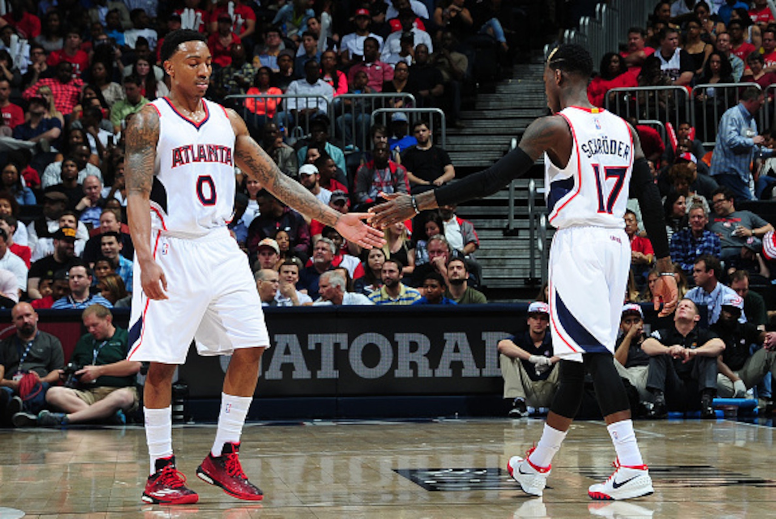 ATLANTA, GA - APRIL 7:  Jeff Teague #0 and Dennis Schroder #17 of the Atlanta Hawks shake hands during the game against the Phoenix Suns on April 7, 2015 at Philips Arena in Atlanta, Georgia.  NOTE TO USER: User expressly acknowledges and agrees that, by 