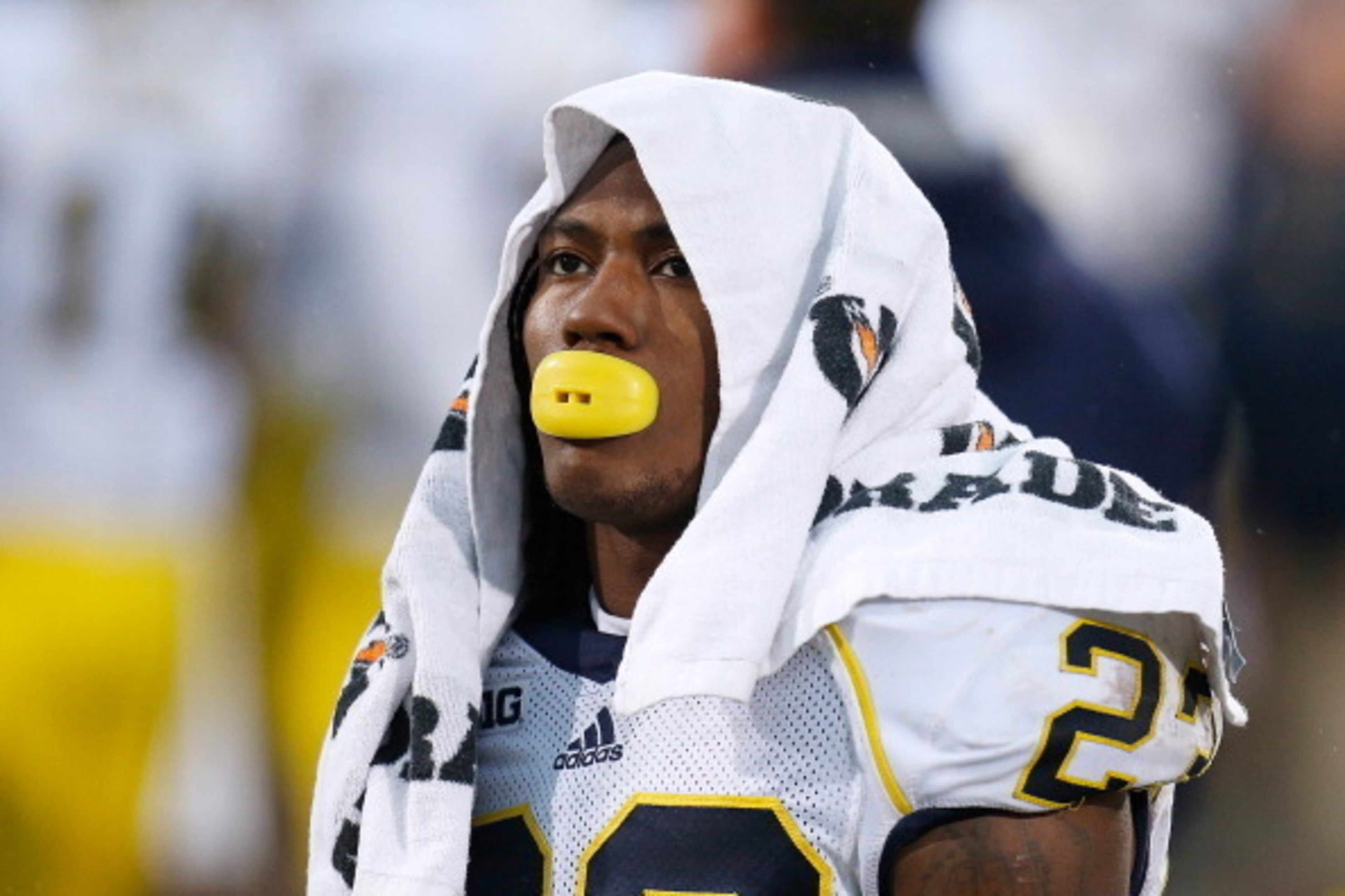 EAST LANSING, MI - NOVEMBER 02:  Dennis Norfleet #23 of the Michigan Wolverines takes a break in the second half during the Wolverines' game against the Michigan State Spartans at Spartan Stadium on November 2, 2013 in East Lansing, Michigan. Michigan Sta