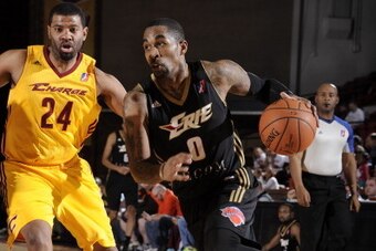 CANTON, OH - DECEMBER 14:  Chris Smith #0 of the Erie BayHawks drives to the hoop against Rashad Anderson #24 of the Canton Charge at the Canton Memorial Civic Center on December 14, 2013 in Canton, Ohio. NOTE TO USER: User expressly acknowledges and agre