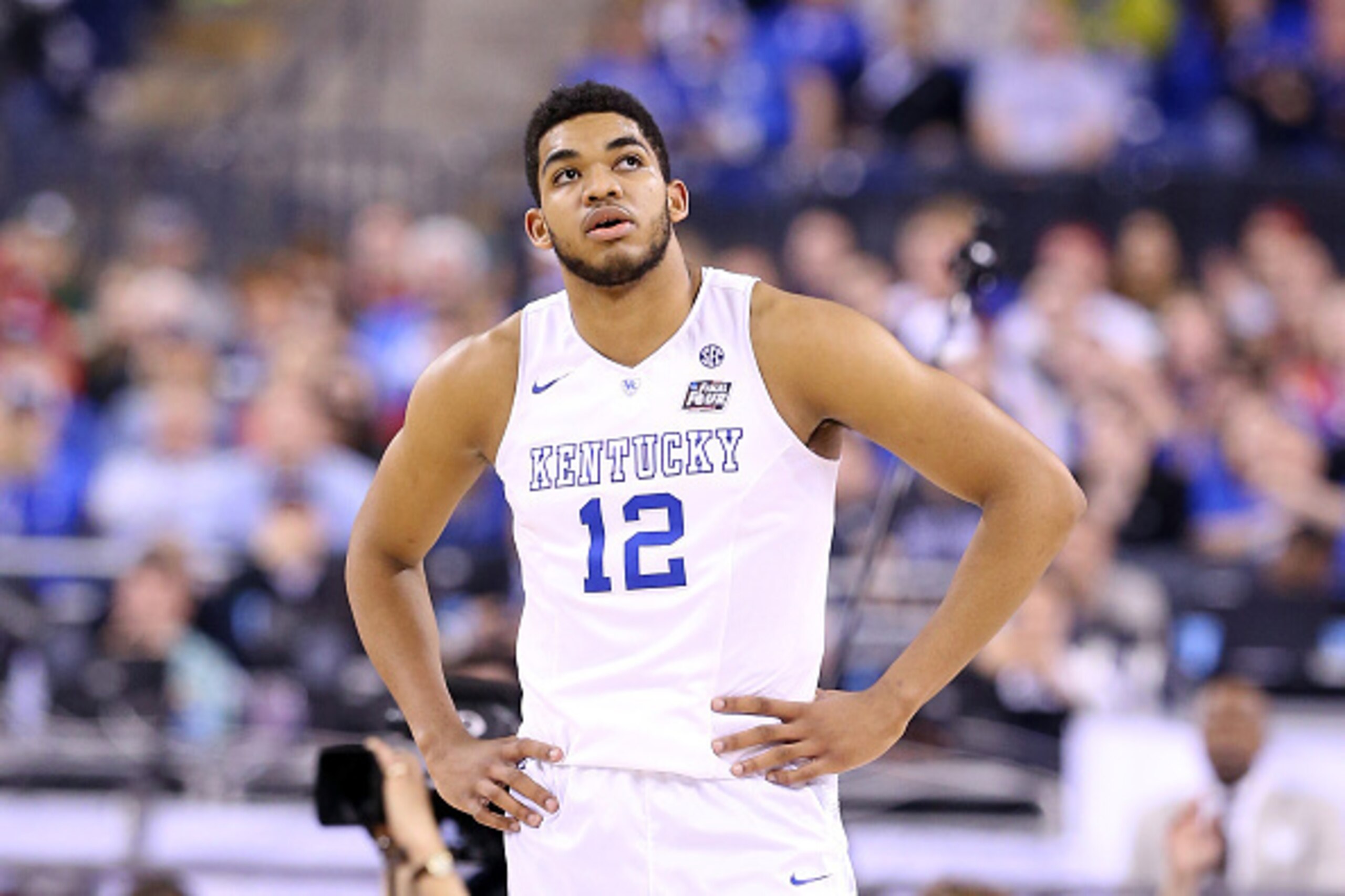 INDIANAPOLIS, IN - APRIL 04: Karl-Anthony Towns #12 of the Kentucky Wildcats looks on in the second half against the Wisconsin Badgers during the NCAA Men's Final Four Semifinal at Lucas Oil Stadium on April 4, 2015 in Indianapolis, Indiana.  (Photo by An