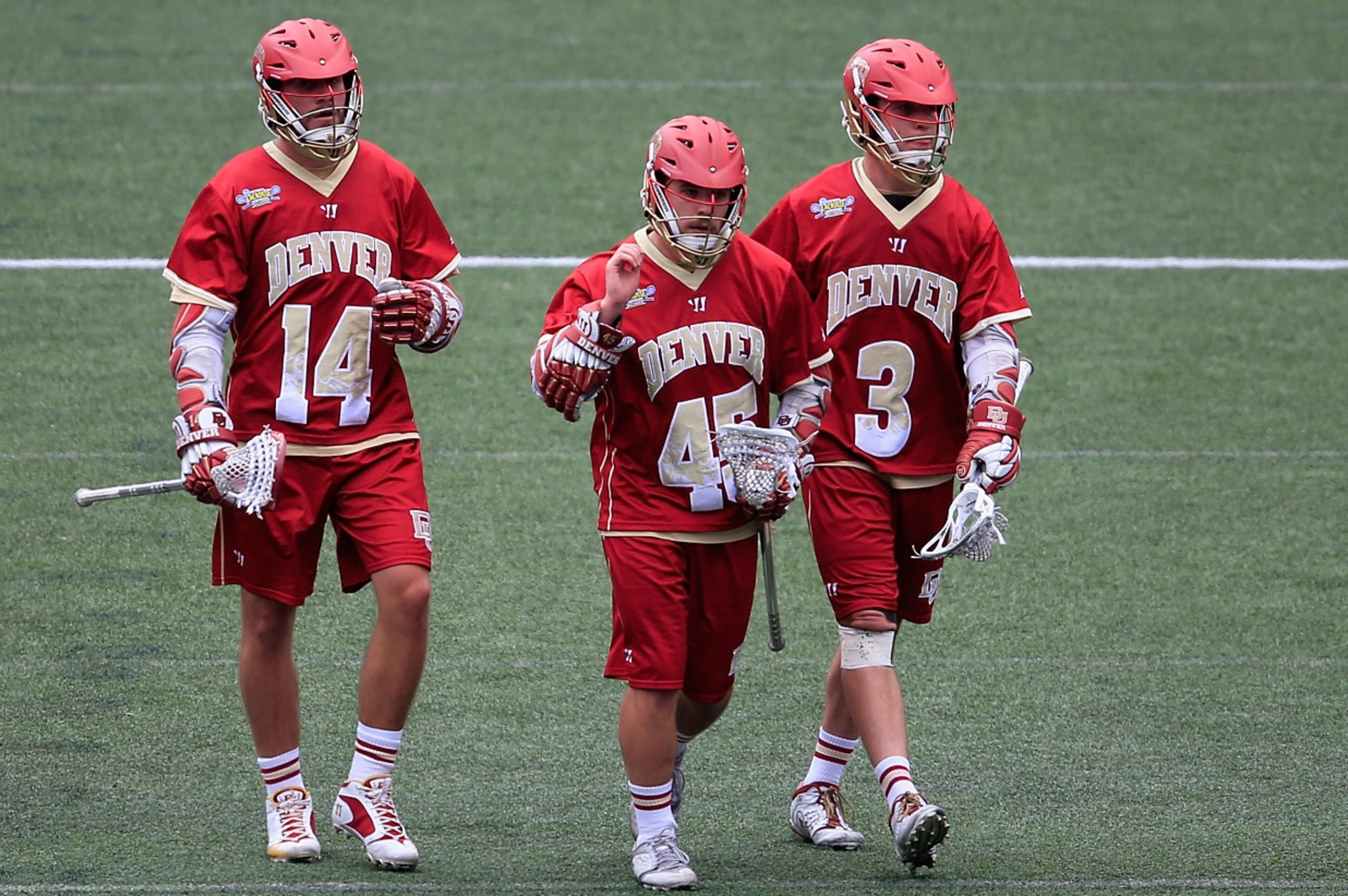 BALTIMORE, MD - MAY 24: Wesley Berg #14, Jeremy Noble #45, and Tyler Pace #3 of the Denver Pioneers walk off the field following their 15-12 loss to the Duke Blue Devils during the semifinals of the 2014 NCAA Division I Men's Lacrosse Championship at M&T