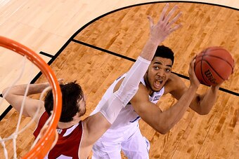 INDIANAPOLIS, IN - APRIL 04: Karl-Anthony Towns #12 of the Kentucky Wildcats looks to shoot against Frank Kaminsky #44 of the Wisconsin Badgers in the second half during the NCAA Men's Final Four Semifinal at Lucas Oil Stadium on April 4, 2015 in Indianap