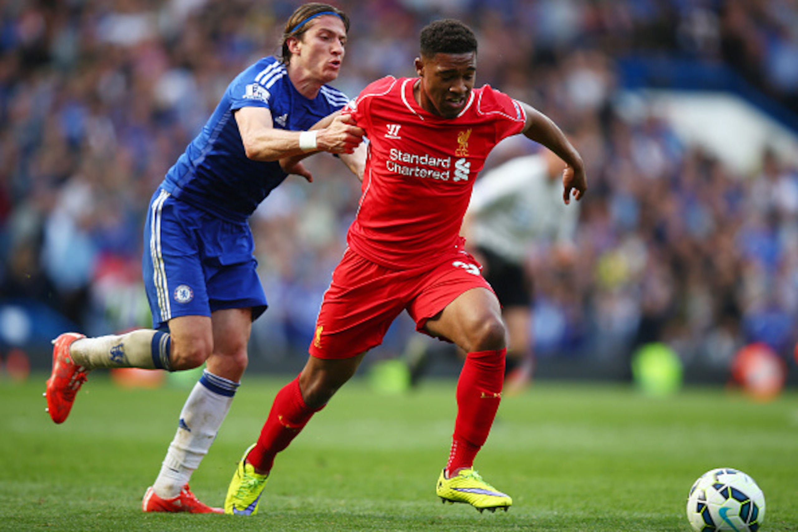 LONDON, ENGLAND - MAY 10:  Jordon Ibe of Liverpool is held back by Filipe Luis of Chelsea during the Barclays Premier League match between Chelsea and Liverpool at Stamford Bridge on May 10, 2015 in London, England.  (Photo by Clive Rose/Getty Images)