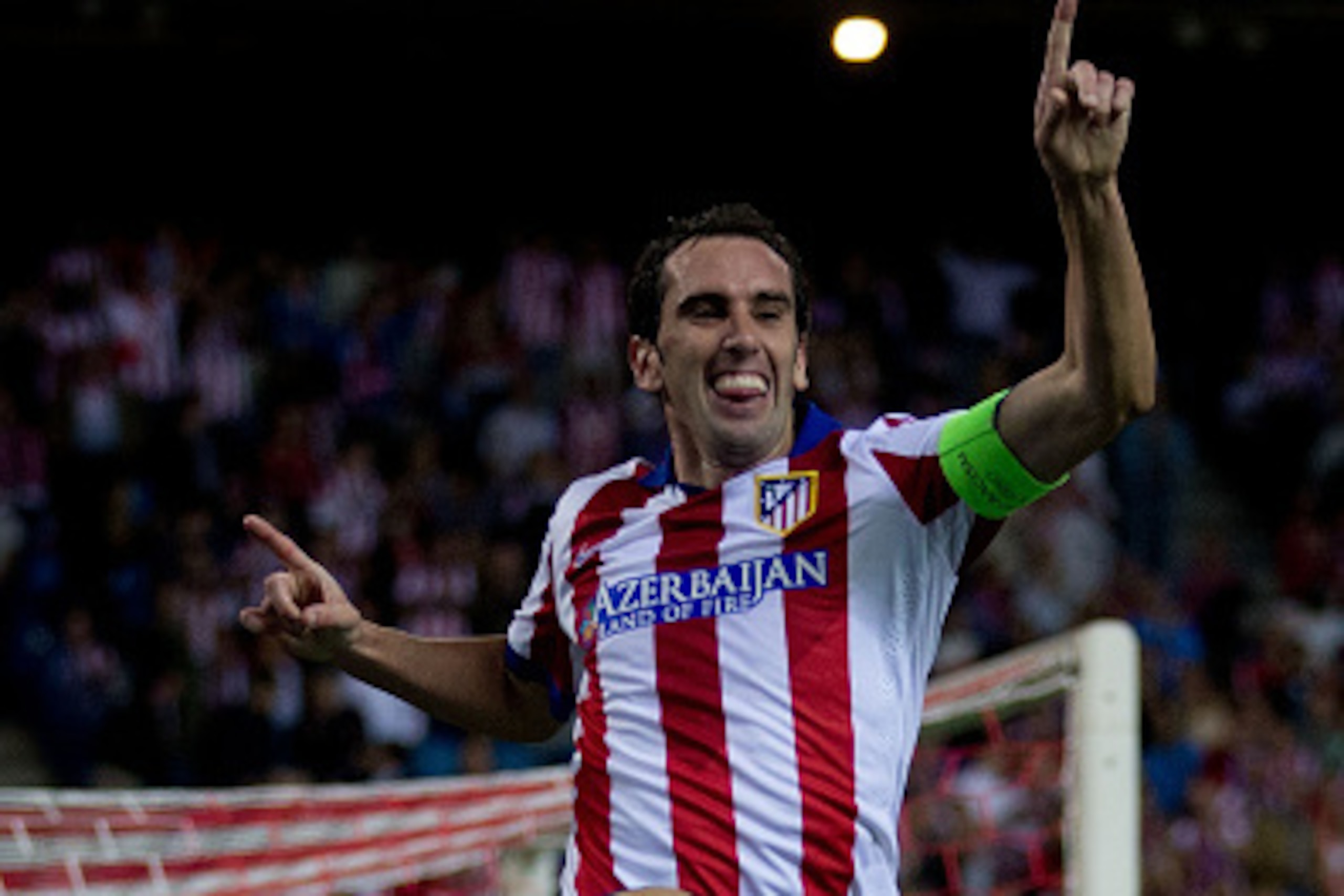 MADRID, SPAIN - OCTOBER 22:  Diego Godin of Atletico de Madrid jumps celebrating scoring their fourth goal during the UEFA Champions League group A match between Club Atletico de Madrid and Malmo FF at Vicente Calderon stadium on October 22, 2014 in Madri