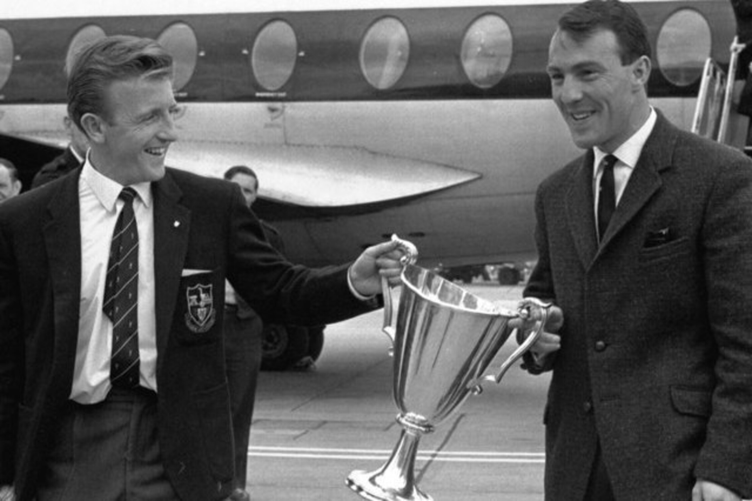 Jimmy Greaves (right) and Terry Dyson carry the European Cup Winners' Cup back to England after two goals from each helped Spurs beat Atletico Madrid 5-1 in the final.