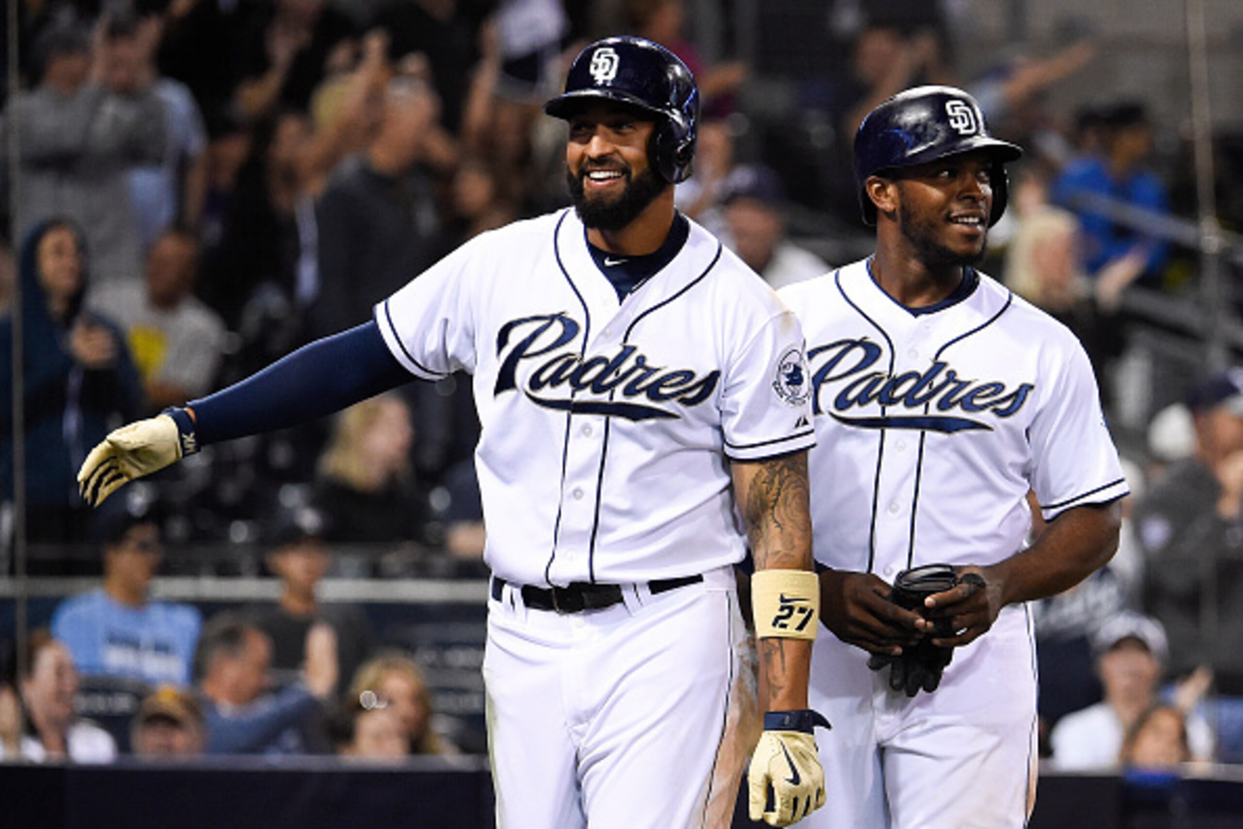 SAN DIEGO, CA - MAY 1:  Matt Kemp #27 of the San Diego Padres, left, and Justin Upton #10  head for the dugout after they both scored during the eighth inning of a baseball game against the Colorado Rockies at Petco Park May 1, 2015 in San Diego, Californ