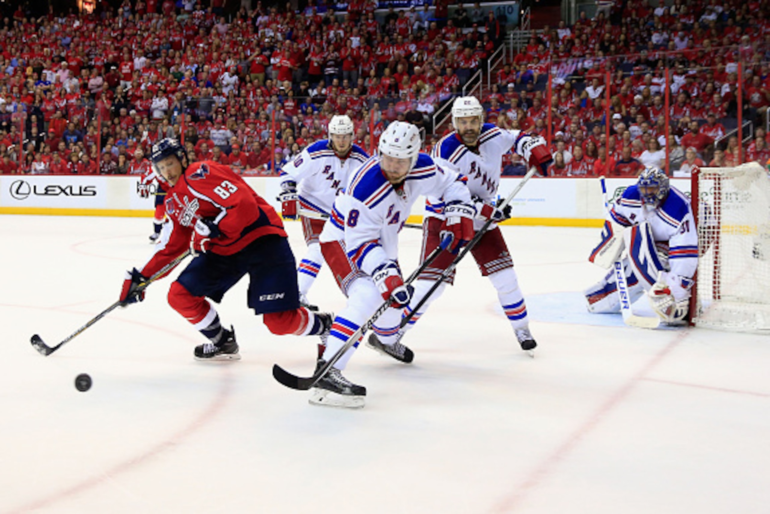 WASHINGTON, DC - MAY 10: Jay Beagle #83 of the Washington Capitals and Kevin Klein #8 of the New York Rangers go after the puck in the third period of the Rangers 4-3 win during Game Six of the Eastern Conference Semifinals during the 2015 NHL Stanley Cup