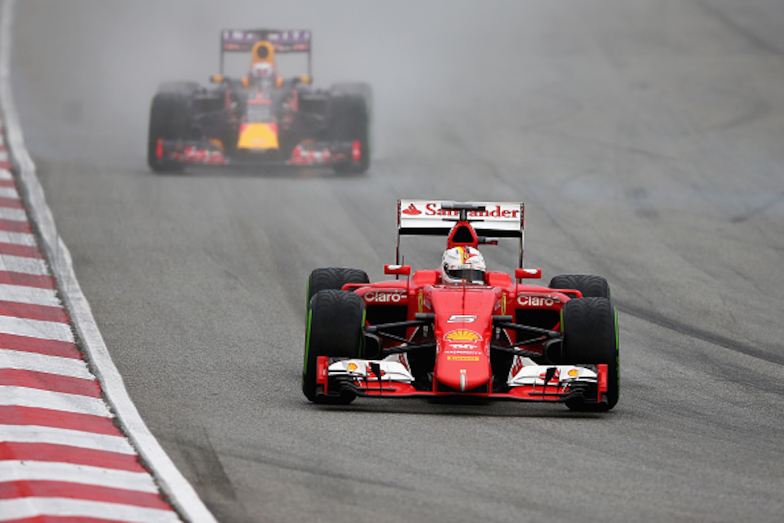 KUALA LUMPUR, MALAYSIA - MARCH 28: Sebastian Vettel of Germany and Ferrari drives ahead of Daniel Ricciardo of Australia and Infiniti Red Bull Racing during qualifying for the Malaysia Formula One Grand Prix at Sepang Circuit on March 28, 2015 in Kuala L KUALA LUMPUR, MALAYSIA - MARCH 28: Sebastian Vettel of Germany and Ferrari drives ahead of Daniel Ricciardo of Australia and Infiniti Red Bull Racing during qualifying for the Malaysia Formula One Grand Prix at Sepang Circuit on March 28, 2015 in Kuala L