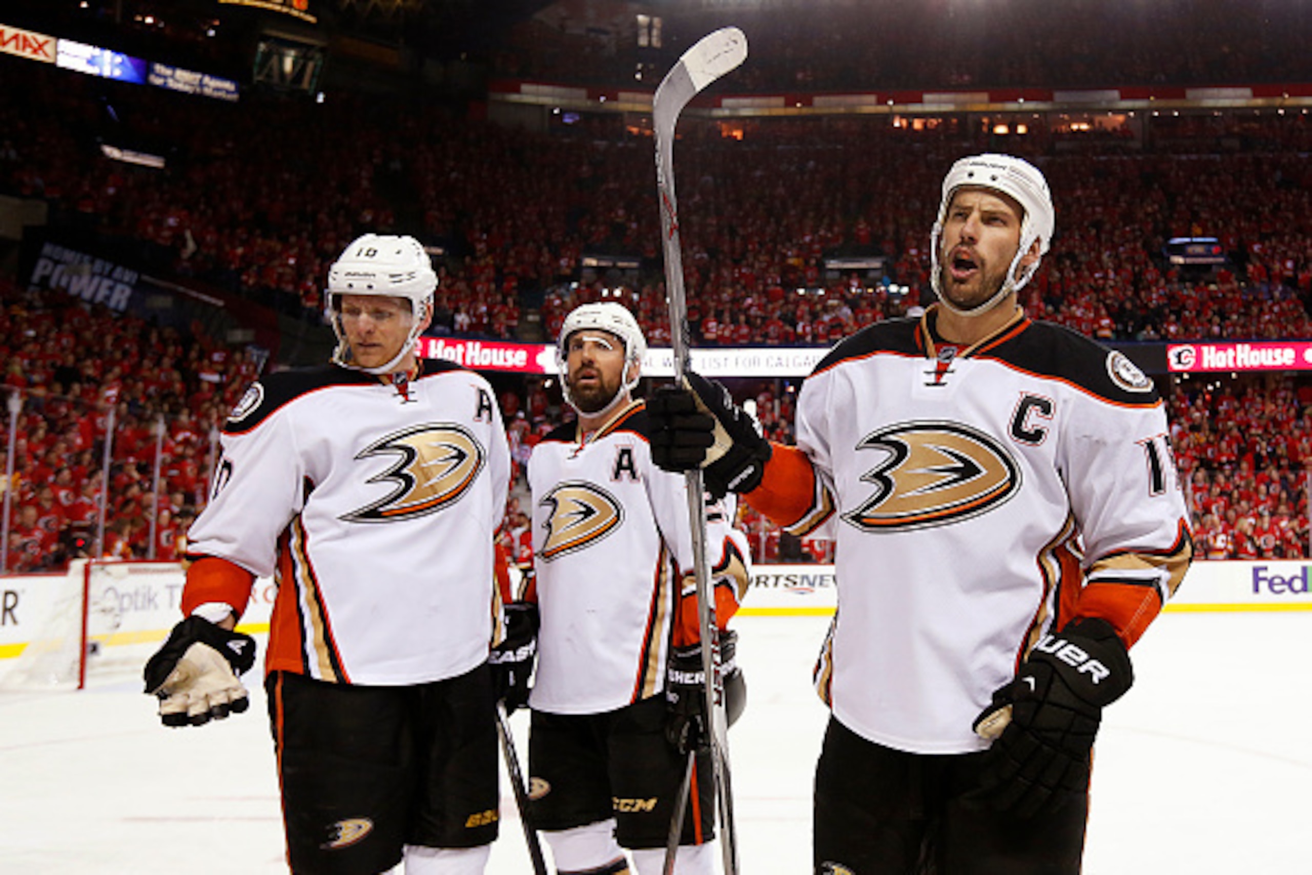 CALGARY, CANADA - MAY 8: Corey Perry #10, Francois Beauchemin #23 and Ryan Getzlaf #15 of the Anaheim Ducks react after fans threw a drink on them after their goal against the Calgary Flames in Game Four of the Western Conference Semifinals during the 201