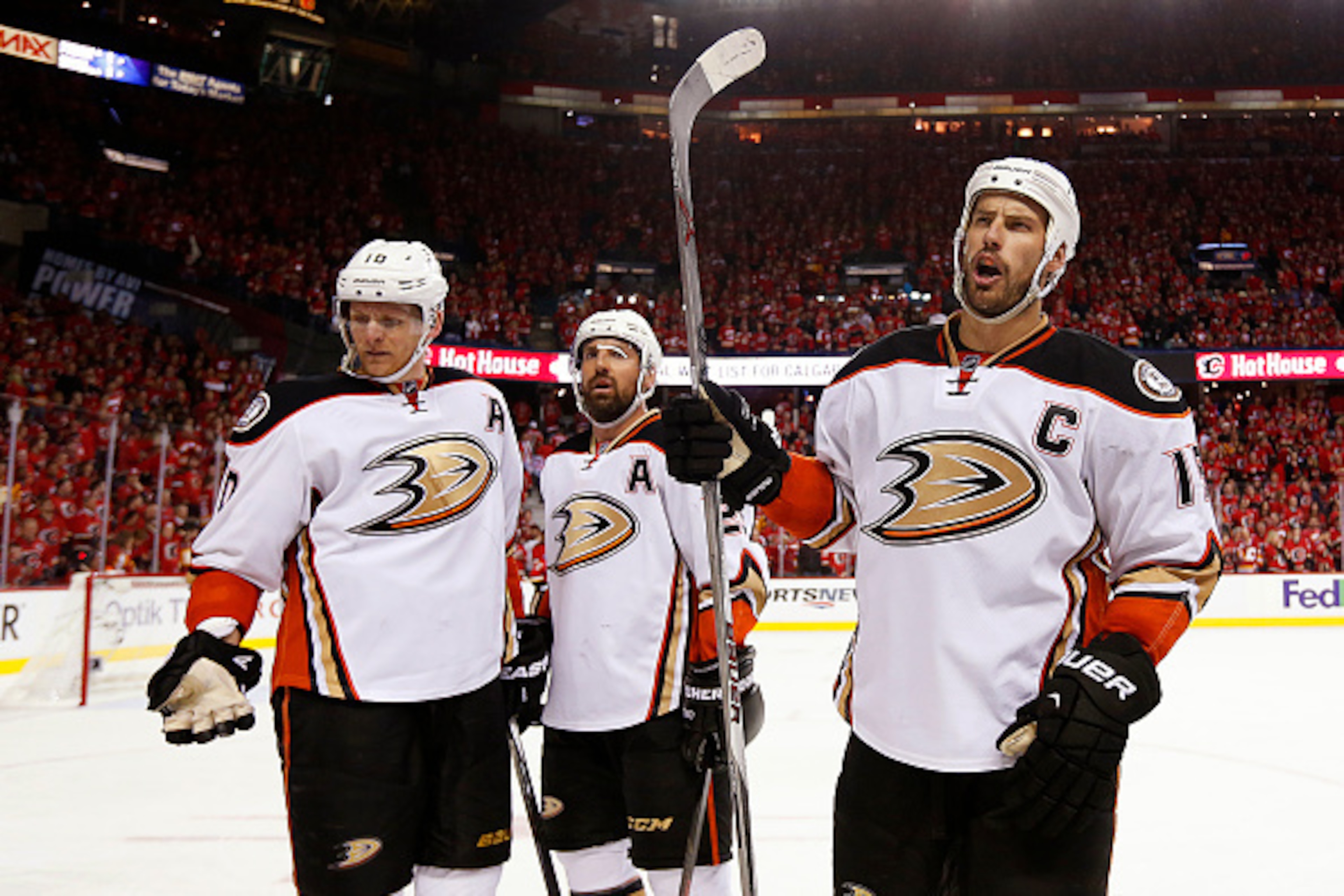CALGARY, CANADA - MAY 8: Corey Perry #10, Francois Beauchemin #23 and Ryan Getzlaf #15 of the Anaheim Ducks react after fans threw a drink on them after their goal against the Calgary Flames in Game Four of the Western Conference Semifinals during the 201