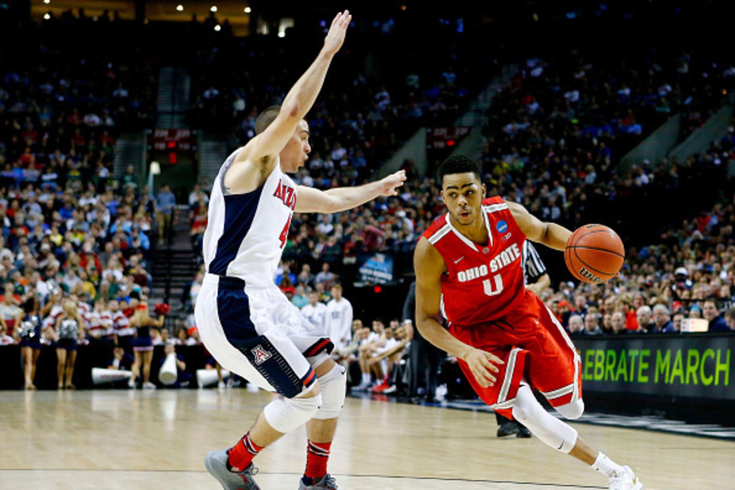 PORTLAND, OR - MARCH 21:  D'Angelo Russell #0 of the Ohio State Buckeyes drives against T.J. McConnell #4 of the Arizona Wildcats in the second half during the third round of the 2015 NCAA Men's Basketball Tournament at Moda Center on March 21, 2015 in Po