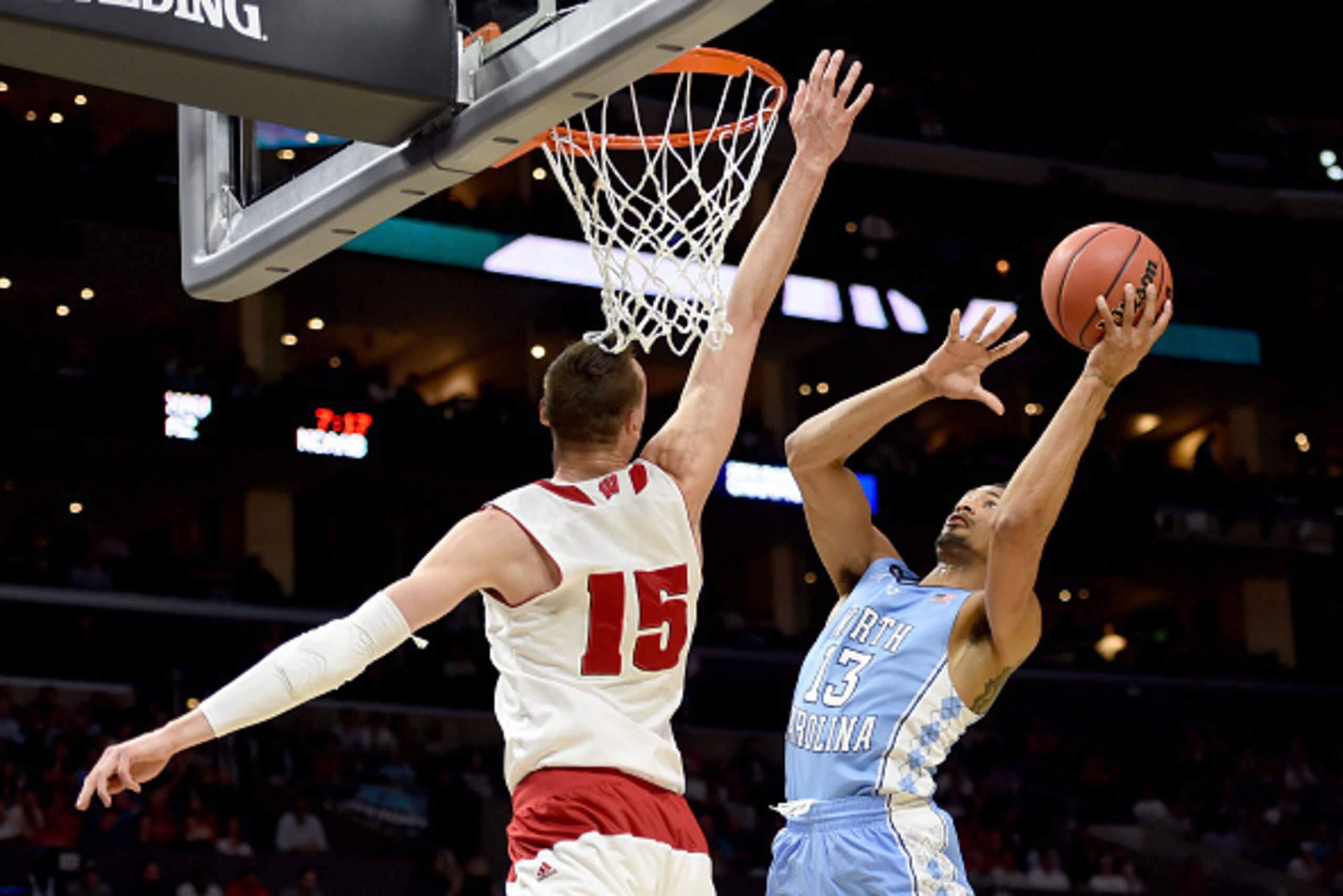 LOS ANGELES, CA - MARCH 26:  J.P. Tokoto #13 of the North Carolina Tar Heels goes up for a shot against Sam Dekker #15 of the Wisconsin Badgers in the first half during the West Regional Semifinal of the 2015 NCAA Men's Basketball Tournament at Staples Ce